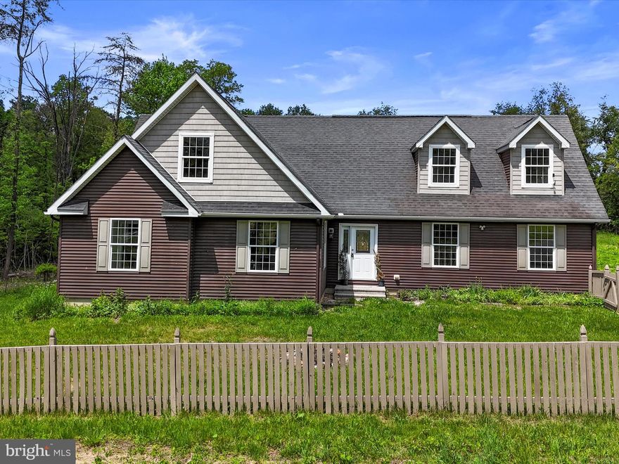 Welcome Home! Beautifully renovated cape cod situated on 3.69 acres of land! Featuring 6 bedrooms, 3 full baths, and boasting over 3,500 sq.ft of living space. Luxury vinyl plank flooring throughout. Main level offers a living room with a gas-burning fireplace. Eat-in kitchen with stainless steel appliances, Quartz countertops, island, ample cabinetry & table space. Separate dining room. Family room with great natural light. Primary bedroom with walk-in closet and en suite with a separate shower, soaking tub, double sinks and separate vanity space. Upper level offers a recreational room, 3 bedrooms, and full bath. Make your way to the back yard where you can enjoy your evenings on the deck taking in the serene setting. Within the town of Hedgesville, convenient to schools, dining, and Route 9. Selling as-is. Home warranty included. Seller is currently working on getting approval to subdivide the property into two lots. You do not want to miss this! Schedule your showing today!