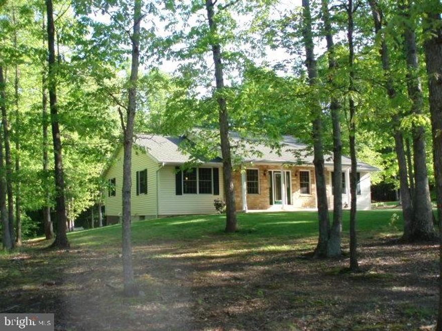 One floor living at its best. This home features an open floor plan, cathedral wood ceilings and hardwood floors. The kitchen has stainless steel appliances (refrigerator & dishwasher brand  new).and granite counters. The home sits on over 1/2 acre wooded lot. Enjoy the private beach and park