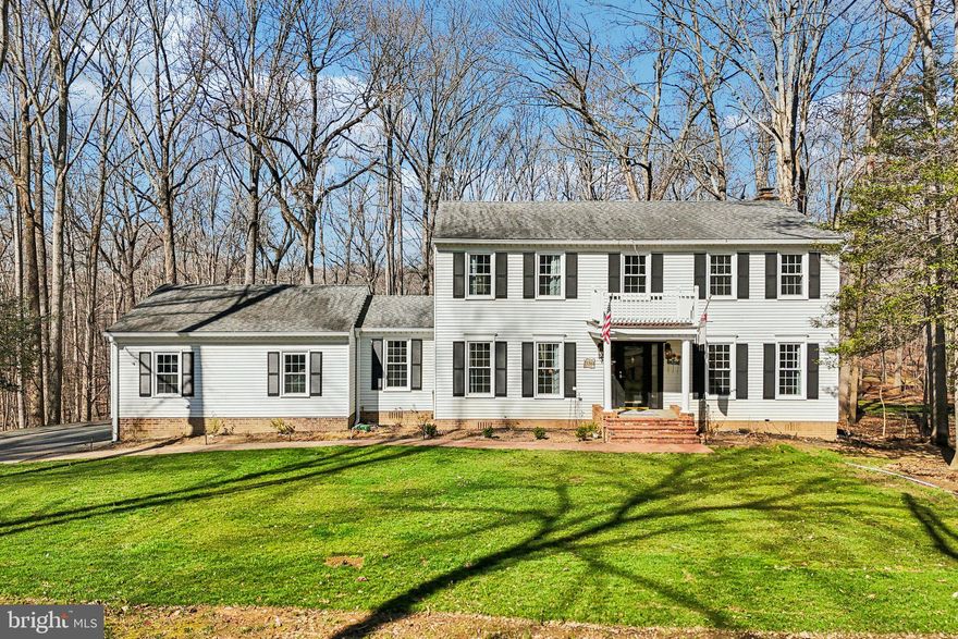 Beautifully updated 4-bedroom, 3-bath colonial set on a private, wooded lot in the highly desirable Woodbine Woods area, offering the perfect blend of classic charm and modern upgrades with abundant natural light throughout. This move-in ready home features a fully renovated kitchen with white cabinetry, quartz countertops, stainless steel appliances, and a large center island ideal for everyday living and entertaining, along with new LVP flooring, fresh paint, and a seamless flow into a bright formal dining room with custom trim work and designer lighting. The spacious bedrooms include a generous primary suite that serves as a true retreat, while additional rooms provide flexibility for guests, a home office, or growing families. The inviting family room showcases a beautiful brick fireplace, creating a warm and comfortable gathering space, while the standout sunroom with vaulted ceilings and walls of windows offers peaceful, tree-lined views and brings the outdoors in year-round. Major updates include all new ductwork on the main level, a well-maintained well, water softener, and reverse osmosis system; the property is expected to pass water inspections, and the septic was pumped in 2025, providing added peace of mind. Set back on a long private driveway with a two-car garage and surrounded by mature trees, this home delivers privacy, space, and convenience in a quiet, sought-after setting. A must-see.