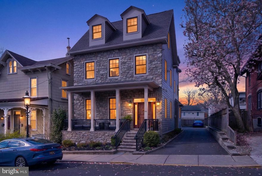 Walk to everything in Doylestown Borough—without sacrificing luxury, parking, or space. A rare 2017 custom-built home offering true in-town living with a 2-car garage, private outdoor space, and future expansion potential just steps from restaurants, the Farmers Market, and year-round community events. 
This exceptional residence blends craftsmanship and comfort with a lifestyle that’s difficult to replicate. A covered front porch sets the tone, perfect for enjoying the energy of the Borough, from the annual bike race to the Art Festival and live music just moments away. Inside, white oak hardwood floors,  main floor 10-foot ceilings, and abundant natural light create a bright, open feel. Custom millwork, architectural details, and a stone fireplace with reclaimed Bucks County barn wood add warmth and character throughout the main living space. The kitchen is designed for both function and flow, featuring GE Monogram appliances, beverage cooler, pot filler, and seamless connection to the living and dining areas, ideal for everyday living and entertaining. Upstairs, the primary suite offers a private retreat with sitting area, balcony access, office alcove, and a spa-inspired bath with soaking tub, oversized shower, and custom walk-in closet. The finished lower level is built for entertaining, complete with a custom bar, beverage and wine refrigerators, dishwasher, and open-concept layout, perfect for hosting or relaxing. Outdoor living extends to a private patio with retractable awning, complemented by professionally designed landscaping and improved drainage for ease of maintenance. Additional highlights include: 9ft Ceilings on upper floors,
Two-zone HVAC and whole-house water softener, Generac whole-house generator, Tesla-compatible EV charger, Security system with cameras, PRE-LISTING INSPECTION completed.  The attached 2-car garage offers a rare bonus: a two-story unfinished space with water, sewer, gas, and electric already in place ready to be customized for a guest suite, office, or studio.  With off-street parking for multiple vehicles and a truly walkable Borough location, this home delivers a combination of convenience, flexibility, and modern living that is rarely available.