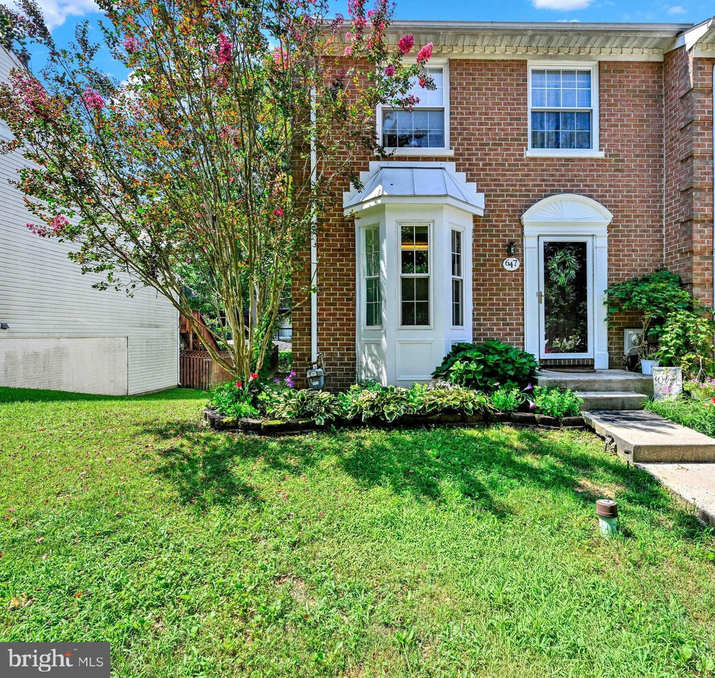 This end of group townhouse in the tranquil Constant Woods community offers exceptional space with 4 bedrooms and 2.5 bathrooms. Positioned on a quiet cul-de-sac, the home provides both privacy and community feel. Recent upgrades include a newer roof, water heater, and HVAC system, complemented by a smart thermostat for efficient climate control. The primary bedroom features its own ensuite bathroom for added convenience. Outdoor living shines with a large deck that steps down to a thoughtfully designed paver patio, all overlooking a generous corner yard with ample space for gardening or play. The practical eat-in kitchen is brightened by a charming bay window that welcomes natural light. You will appreciate the convenient proximity to various shopping and dining options just minutes away. This well maintained home balances modern updates with comfortable living space in a desirable location.