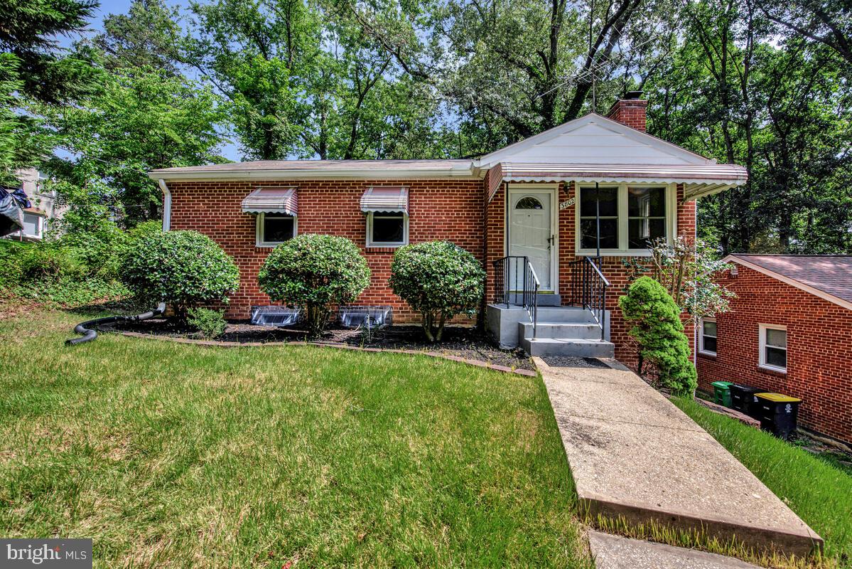 Tucked into a serene, tree-lined street in Temple Hills, this charming all-brick ranch-style home offers timeless character and space to personalize. Whether you're a first-time buyer, investor, or looking to downsize, this property is a perfect opportunity to own a home with great bones and incredible potential. Step inside to find a light-filled interior, three generously-sized bedrooms, 1.5 bathrooms, and original hardwood floors throughout most of the main level. The spacious living area features a cozy wood-burning fireplace. The eat-in kitchen includes a pantry and offers a practical layout with ample cabinet space. The primary bedroom features a ceiling fan and a deep closet, while the two additional bedrooms provide flexibility for guest rooms, a home office, or hobbies. The recently renovated main full bath is centrally located off the hallway. Downstairs, you’ll find a half bath with a rough-in for a future full bath, ideal for guests or future finishing. The partially finished basement includes a laundry area with a utility sink and generous space for storage, workshop use, or expansion potential. Outside, enjoy a gently sloped front lawn and a covered entry porch that enhances the home’s classic curb appeal. The large fenced backyard provides privacy, mature trees, and room to relax, garden, or entertain. Located just minutes from National Harbor, shopping, metro access, and major commuter routes, 3802 Crystal Lane blends peaceful suburban living with everyday convenience.