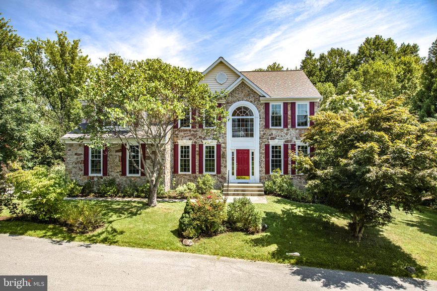 Situated on a cul-de-sac backing to Patapsco State Park in the prominent community of Governors Run is this eye-catching stone front colonial boasting enriched hardwoods, generous sized rooms, a private study, a formal living room and dining room with beautiful natural light and heightened windows, and a 2-story family room with a vaulted ceiling, and a myriad of windows surrounding a stacked stone fireplace. In the lower rear is a rejuvenating sunroom with ceramic tile flooring, a full window surround, and a walkout to a grill patio and backyard. Best dishes can be prepared in the cook's kitchen featuring a center island with a breakfast bar, 42" wood cabinetry, granite counters, a full appliance package including a cooktop, and an open breakfast room with glass slider access to a low maintenance deck. Upstairs and steeped in modern tradition, this owner’s suite presents a vaulted ceiling, a walk-in closet, a sitting room, lots of wall space for furniture placement, and a garden bath displaying a double vanity, a separate shower, and a corner soaking tub. Entertaining good times happen in the lower level finished with an exercise room and walkout, a rec room, and plentiful storage. Highly-desired community is just minutes away from fine dining, shopping, historic Ellicott City, downtown Columbia, commuter routes, parks, and more!