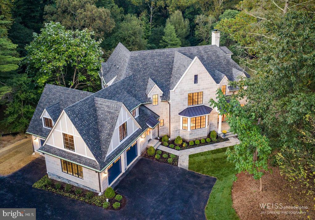 Just completed ...this custom masterpiece is like no other new construction property on the Main Line!! Built by Mark Weiss (who also just completed the 2019 Philadelphia Design Home) for current owners, this magnificent creation is quietly nestled at the end of a cul-de-sac embracing the rich architectural heritage of the Lower Main Line while it is infused with modern touches for a totally fresh look. From the moment you open the front door a canopy of green from the outside gracefully embodies the soul of the home through a wall of glass curtains providing a feeling of serenity and being one with nature. The sophisticated floor plan was skillfully designed to flood the open spaces with natural light and is harmoniously balanced by the warmth of magnificent wide plank Norwegian White Oak hardwood flooring. Every design element of this magical home was meticulously chosen to carefully choreograph the flow of the open spaces from room to room. A soothing palate of a soft white to deep blues, to grays and black create a warm and welcoming atmosphere that gracefully flows throughout the house. The indoor spaces are complimented by the outdoor spaces including a screened in-porch with fireplace and mahogany deck overlooking the property's storybook setting and promises to provide years of cherished memories. The Second Floor has a stunning Master Suite with His and Hers Master Baths and Closets. Additionally, there are three other Suites with private Baths, and large flexible space that could be finished as a Fifth Bedroom Suite, Office and/or Playroom for kids. This One Of A Kind Gem is quietly nestled on over 1.5 acres with pond views and finished by a Three Car Attached Garage. Do not miss one of the most exquisite and special properties in Lower Merion !! A true treat to see!!