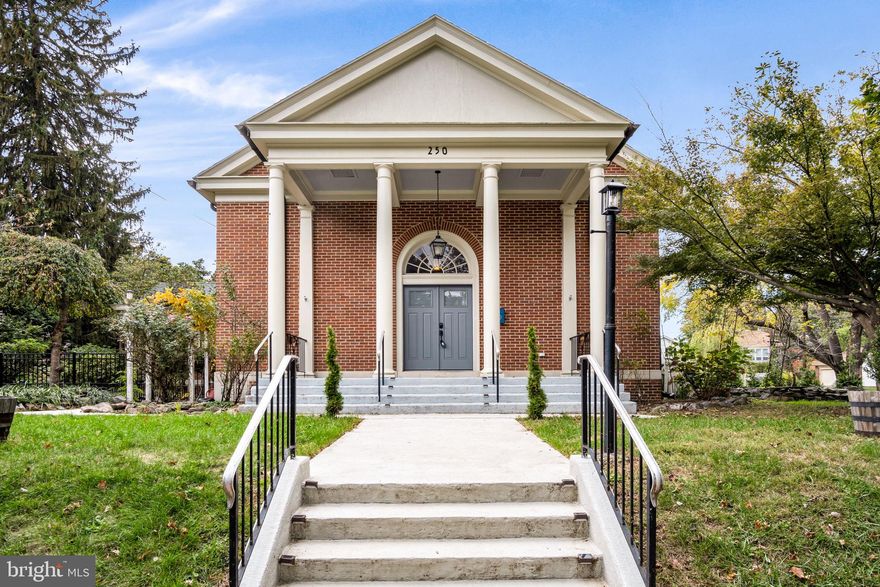 Welcome to a truly unique residence in the heart of Old Mooreland—a former church building thoughtfully converted into a home in 2005. With 15-foot ceilings and expansive, light-filled spaces, this property beautifully combines historic character with modern comfort.

The home offers enviable open space and creative living. Upon entry, you’re welcomed into a spacious receiving room designed to accommodate guests comfortably. A convenient mudroom and half bath serve this area well.

The enormous great room provides flexibility for various furniture arrangements and living zones, allowing endless possibilities for entertaining or relaxation. The kitchen sits a few steps above this magnificent great room, offering a full view of the main living area. Original wood flooring grounds this updated, well-appointed kitchen, which includes a high-end Wolf stove and ample workspace.

The great room features a wood-pellet stove—creating a cozy nook for reading while providing excellent energy efficiency. The home has been updated throughout with energy-efficient windows, added insulation, a new roof, and state-of-the-art Casablanca ceiling fans.

The primary bedroom includes a large walk-in closet and a private bathroom remodeled in 2021 with heated tile flooring. There are **four additional bedrooms and a lounge area**, offering flexibility for family, guests, or work-from-home needs. A second fully renovated bathroom, located next to the guest room, includes a soaking tub.

Before stepping outside, you’ll pass the laundry room and additional storage space. The private courtyard features a brick patio with a fence, ideal for grilling, gardening, and entertaining. Mature landscaping provides both beauty and privacy, creating an outdoor oasis perfect for relaxing or hosting guests.

Finally, the property offers a detached two-car garage, a shed, and rear parking.