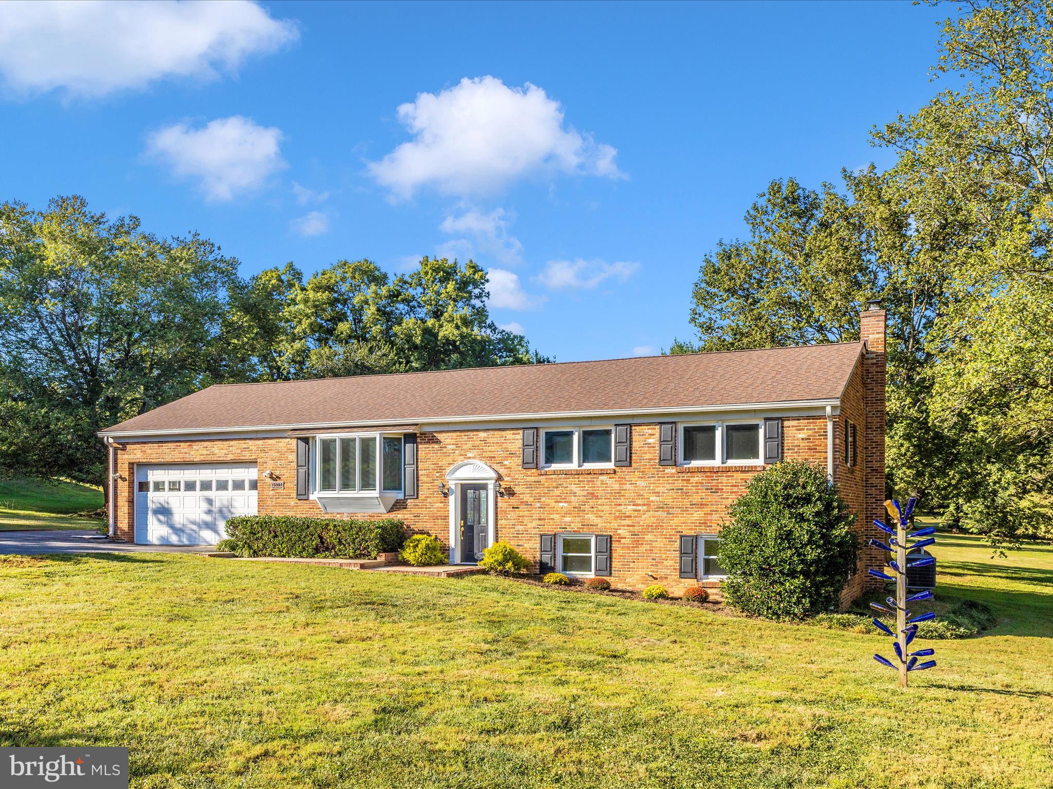 Welcome to this inviting split foyer home in the sought-after Woodbine area of Howard County. Set on a scenic 1.5-acre lot, the property boasts beautiful landscaping, mature trees, and a spacious deck ideal for entertaining or simply relaxing in the peaceful surroundings. Inside, the main level features gleaming hardwood floors and an expanded kitchen designed for both function and style. The primary suite has been thoughtfully enlarged to include a spacious bathroom, creating a private retreat. Numerous updates provide peace of mind, including Andersen replacement windows, bathrooms, an architectural shingle roof only eight years old, and a brand-new A/C unit. A great workshop space is convenient to the garage and main living pace of the home with a double door access to rear yard. The home has been well maintained throughout. Offering the best of both worlds, it combines a rural setting with easy access to nearby conveniences and commuter routes to Washington, D.C., Frederick, and Baltimore. With the bonus of high-speed internet, this property is perfectly suited for today’s lifestyle. NO HOA, plenty of parking in driveway and attached 2 car garage.