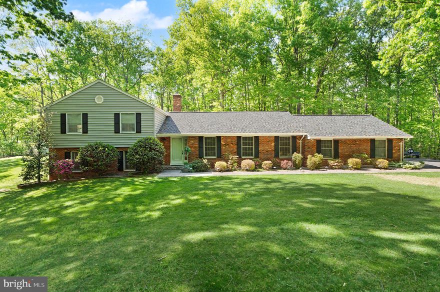 Tucked away on nearly 6 acres of serene, wooded land, this beautifully updated 3-bedroom, 2.5-bath split-level home offers the perfect blend of comfort and space. Hardwood floors span the entire main level, where formal living and dining rooms with elegant decorative moldings create an inviting setting for entertaining.

The kitchen features ceramic tile flooring and backsplash, a walk-in pantry, and a brand-new dishwasher, all overlooking the cozy family room complete with a brick gas fireplace and built-in bookcases. Step outside through sliding glass doors to an expansive stamped concrete patio with a decorative stone retaining wall—ideal for summer gatherings and relaxing evenings.

Upstairs, you’ll find all bedrooms with brand-new carpet. The spacious primary suite showcases plantation shutters, chair rail detailing, dual walk-in closets, and a newly remodeled en suite bath with a furniture-quality dual sink vanity, quartz countertops, a stylish frameless LED mirror, and a large walk-in shower. Two additional bedrooms, both with walk-in closets, and an updated full bath complete the upper level.

The bright walkout lower level offers a generous rec room with new LVP flooring, full-size windows, and dual storage closets, including a cedar closet. A large unfinished area with abundant cabinetry provides exceptional storage and organization space.

Additional highlights include an oversized two-car garage, paved driveway with ample guest parking, and a stunning 5.8-acre wooded lot featuring two storage sheds and a dog kennel with run. Recent updates for peace of mind include a new washer (2026), roof (2025), and HVAC (2023). No HOA.

Enjoy the tranquility of your own private land while coming home to a beautiful, move-in ready retreat.