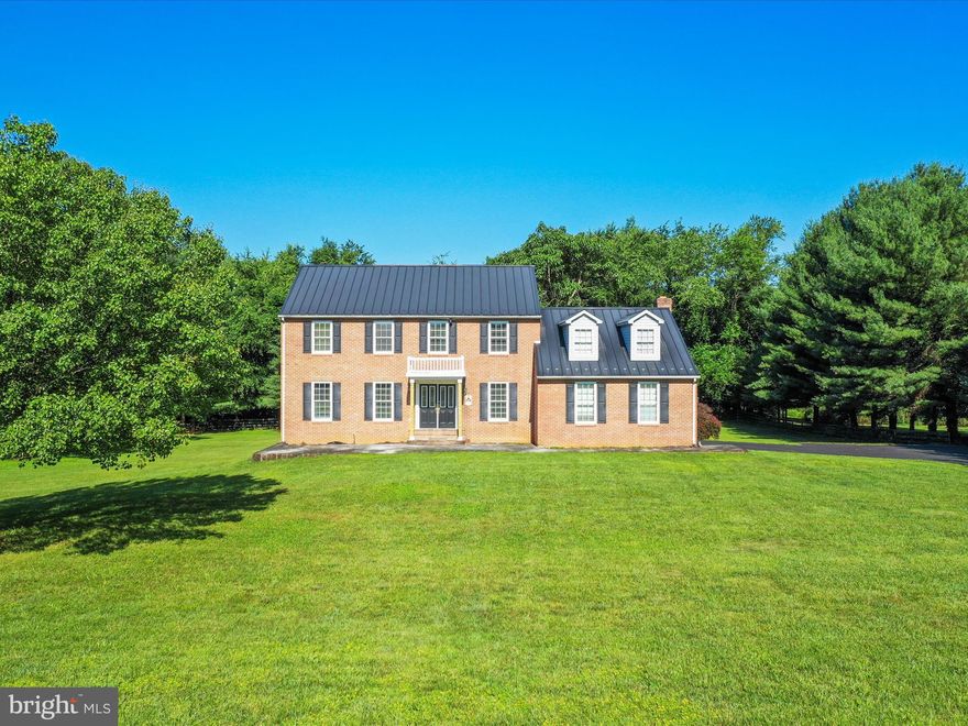 Welcome to your own slice of Almost Heaven West Virginia. This home offers so much space inside and out. The level, three-acre, partly wooded lot allows for privacy while still enjoying your wide-open spaces. A large slate patio welcomes you at the front of the home. Imagine quietly greeting the sunrise and sipping your morning coffee here or hosting a gathering of friends and family. Inside you will find plenty of elbow room with over 2,500 square feet of usable space. Sizable rooms including a dedicated office space permit plenty of flexibility. The spacious kitchen features granite counters, under cabinet lighting, and more. The family room invites you to cozy up to the woodburning fireplace or flow out onto the rear deck. Wrap up your day here enjoying the quiet and watching for wildlife. The partially fenced yard is perfect for your outdoor celebrations and game playing. Even more adventure awaits in the wooded portion of this three-acre lot. Back inside on the second floor, you will find four generously sized bedrooms and plenty of storage. The primary bedroom features a large walk-in closet and ensuite bathroom. This home is priced to accommodate cosmetic changes you may desire, but the major systems – metal roof, HVAC, water heater – have been updated within the last ten years. The full basement has high ceilings, a walkout to the rear yard, and a work bench area providing many options for use. There is approx. 2,500 feet of invisible pet fencing around back and front yards. All this plus an attached oversized garage and a shed just minutes from major commuter routes. Welcome home to Almost Heaven!