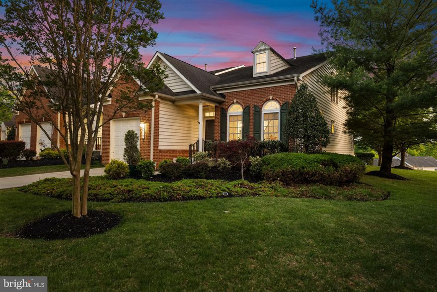 The Villages at Woodholme is Pikesville's premier 55+ gated community and is loaded with amenities! Simply perfect!  This end-of-group home is in absolutely pristine condition and boasts an impressive amount of upgrades and improvements, soaring ceilings, abundant natural light and generous room sizes. The spacious layout allows for true 1-level living with plenty of additional space for visitors and entertaining! Just a few steps outside the primary bedroom and you're in the kitchen for the morning's coffee which you can enjoy in the adjacent sunroom or on the deck - either in the warm sun or under the shade of the automatic awning.  You'll love cooking in this well-designed kitchen with abundant 42-inch cabinetry, granite counters and recent stainless steel appliances and you'll be proud to serve those formal dinners in the dining room, surrounded by your finest artwork, all illuminated by museum-quality artwork lighting system by Jones Lighting! Host your favorite team's "watch parties" in the expansive, fully finished lower level that boasts surround sound and a full wet bar with mini fridge and dishwasher! Working from home couldn't be easier with the handsome and practical built-ins in the lower level office.  This immaculate property offers gorgeous spaces, both inside and out, for maximum enjoyment with minimal, if any, maintenance! The active adult community of the Villages At Woodholme offers a wide variety of amenities, including a community center with social events, library, meeting and media rooms and a fitness center. Outdoors you can enjoy the pool, tennis/pickeball courts, putting green, patios, gathering spaces and walking/joggings paths.