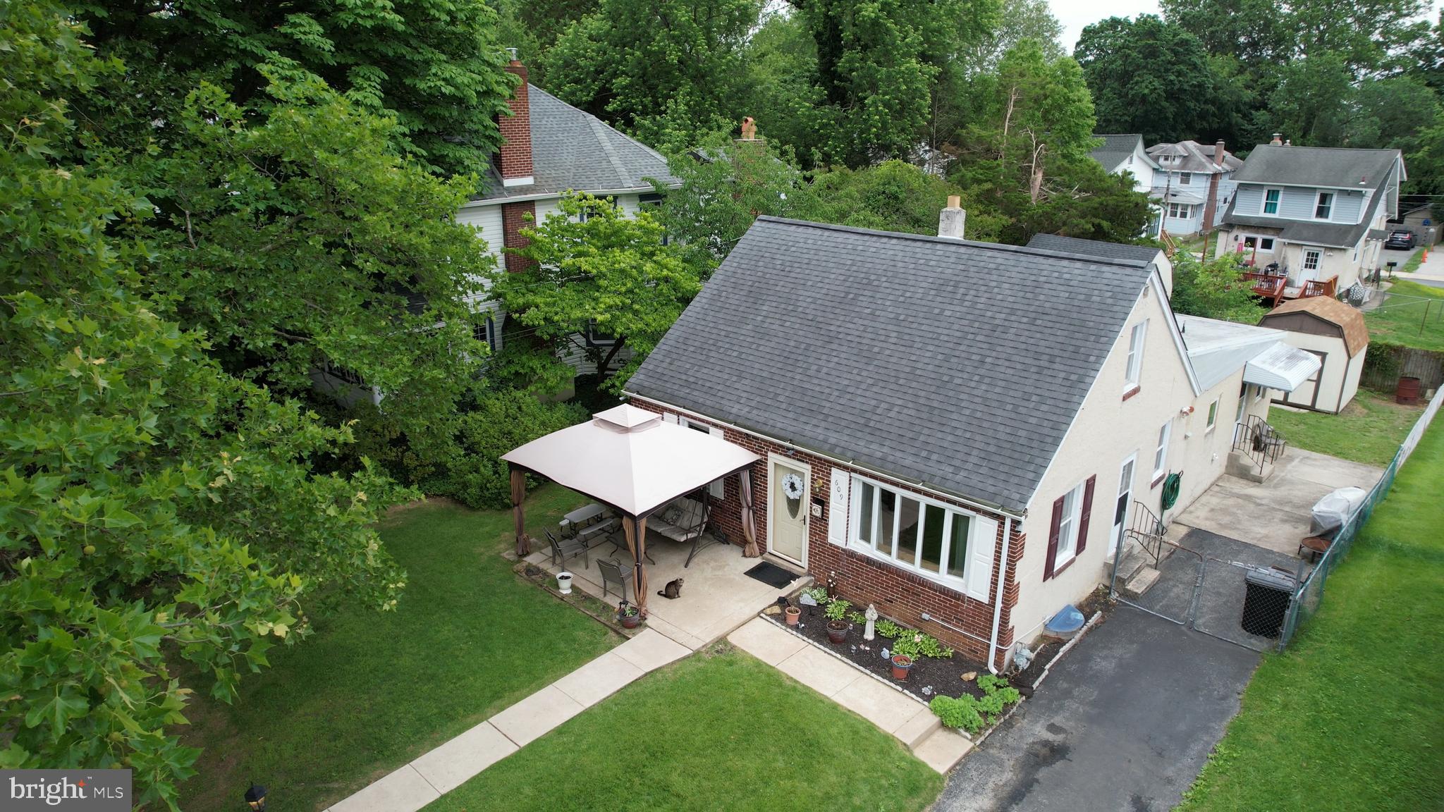 Welcome to a beautifully expanded brick Cape Cod offering approx 2,100 square feet of versatile living space in the heart of Glenolden Borough, within the award-winning Interboro School District. This lovingly maintained home is full of flexibility, comfort, and opportunity — perfect for families, multi-generational living, or buyers seeking flexible space.
Step inside to discover a warm and inviting layout featuring 4 spacious bedrooms and 2.5 bathrooms in total. The "front of the house" offers the main living room, main bedroom, a bonus room that could be a closet, pantry, or other, an updated hall bath, and steps to the 2nd floor. The 2nd floor features a loft space that leads into a generous bedroom with en suite half bath. Could be great teen space, in-laws, or even flex/home office space. The large eat-in kitchen has been nicely updated with stainless steel appliances serves as the heart of the home, with plenty of room for cooking, dining, and gathering, while being the center point for both living spaces and it's own outside access. Off the back of the kitchen is the addition. This could be an in-law quarters or simply extended living. This large space features a main living/family room space with laundry closet, is separately zoned with electric baseboard heat and a wall AC unit, as well as another full and updated bath, and 2 additional and spacious bedrooms complete with it's own outside access to the driveway.
Outdoors, enjoy relaxing evenings on the welcoming front patio or entertain in the fully fenced backyard. The property also features multiple storage sheds for tools, hobbies, or seasonal items, and offers private driveway for 3-4 cars and additional off-street parking for added convenience.
With a lot size of 50' x 120' (over 6,000 sqft) and a traditional yet adaptable layout, this home is ready to meet your needs today and grow with you tomorrow. Enjoy the virtual tour available
