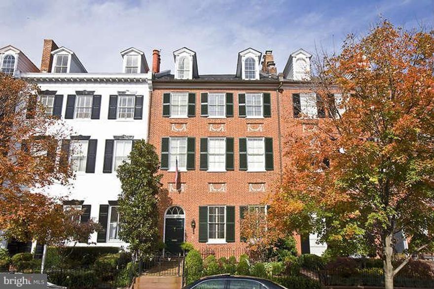 One of the most elegant homes in Georgetown, this true 1817 Federal on Cox's Row includes grand entertaining and living spaces. Features a double parlor living room with two fireplaces, a gourmet chef's eat-in kitchen, separate dining room, exquisite details and finishes throughout, and a beautiful garden terrace and pavilion. 3-car parking. Architect and builder designs for elevator available.