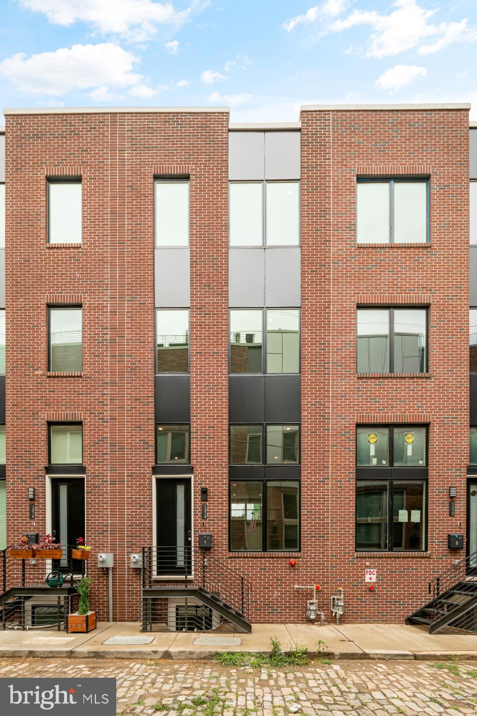 UNDER CONSTRUCTION.  Welcome to Wharton Court, the largest luxury development in Point Breeze! These extravagant townhomes offer a unique, carefully designed floor plan that offers both traditional touches and modern concepts. This is a 1 car Garage Parking home. In addition to parking, all homes feature stunning views from your private roof deck, finished basements for an office or secondary living room, 14' ceilings in the main living room, an abundance of natural light throughout. Homes in Wharton Court start with 2,350 sqft and sit on a 16.5' wide lot and then get larger from there! Love Philly living when you pull into your garage that leads directly into your main living quarters. The main living room consists of a uniquely designed living room that boasts a tall 14' ceilings and a convenient powder room. The kitchen and dining area overlook the living room and offer a sleek glass railing that eliminates sight lines and creates a more spacious home feeling not to mention adding more natural light. To make your kitchen even more special - you have design choices! Choose your cabinet style and color, countertops, and backsplashes from our selections to truly make this home yours! The kitchen comes standard with stainless steel appliances and a spacious and thoughtful layout that would make any aspiring chef extraordinarily happy. Continue up the floating staircase with more glass railings up to the owner's floor. That's right, less steps from the kitchen and living room make this more convenient than other new construction homes and the ENTIRE floor is yours! You'll find everything you could ever want for an owner's suite - a bathroom, with it's large soaking tub (upgrade), to create your own spa experience, a massive shower with a floor to the ceiling glass wall, an 8' long vanity system , not to mention a massive walk-in closet and a substantially sized bedroom. The next floor up is where you'll find 2 more bedrooms with large closets and ultra-rare windows that allow for tons of sunlight and wonderful views. Also on this floor is your laundry closet (side by side configuration), and a optional/upgrade dry bar with a wine fridge for when you're entertaining on the roof deck where you'll be enjoying the extraordinary city skyline views. Each home comes with a standard smart home solution featuring smart thermostats, door lock, and video doorbell; all controlled with your phone or tablet. Wharton Court is located in the heart of Point Breeze, one of Philly's fastest-appreciating neighborhoods. Our exclusive townhomes are conveniently located minutes from Center City, University of Penn and Drexel University, CHOP, and I-76. This home is currently being built, Taxes are estimated, full 10yr tax abatement is approved. Some finish choices may vary and change due to supply issues. Some of the features shown may be upgrades. Specifications, details, and finishes are subject to change. Pictures are of similar home constructed by builder in same project.