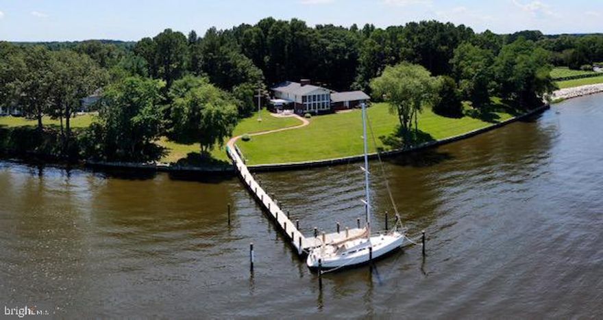 OPEN HOUSE HAS BEEN CANCELLED. Sellers accepted an offer. Sailor's Paradise on the Wye River with 8 feet MLW with a summer range about 8-10 feet. This unique property is on 2.88 acres with over 3600 square feet of living space nestled in the farmlands of Maryland in Talbot County. Three fireplaces, a wall of windows overlooking the Wye River, a cockpit/conversation pit in front of one of the fireplaces and a hanging table in the great room are just some of the things that make this such a unique home. Upon entering the home, one is greeted with a two story entrance hall that highlights the open floor plan. One is drawn, however, to the spectacular water view from the two story great room that has twelve 4’x8’ floor-to-ceiling picture windows over-looking a large expanse of lawn to the 450 feet of waterfront on the Wye River and the newly constructed pier. Across the river are only trees on Wye Island and the view of Dividing Creek, hence the name of the house “Dividing Views”. The beautiful blue ceiling of the great room is highlighted with a well-known constellation depicted in lights. The flooring is Pennsylvania blue slate. The home also offers the "River Room" with an indoor BBQ, quarry tile flooring, a stamped metal ceiling and two sides of glass that give a wonderful view of the Wye River. The pier was replaced in 2019 and is 5ft x 110 ft with an 8ft end platform. The slip has Tide Slides so you don't have to adjust the lines and an ice bubbler. Once you visit this property, you will not want to leave. When you find the right home it will speak to you. The owners hope Dividing Views says as much to you as it did to them. Welcome Home.