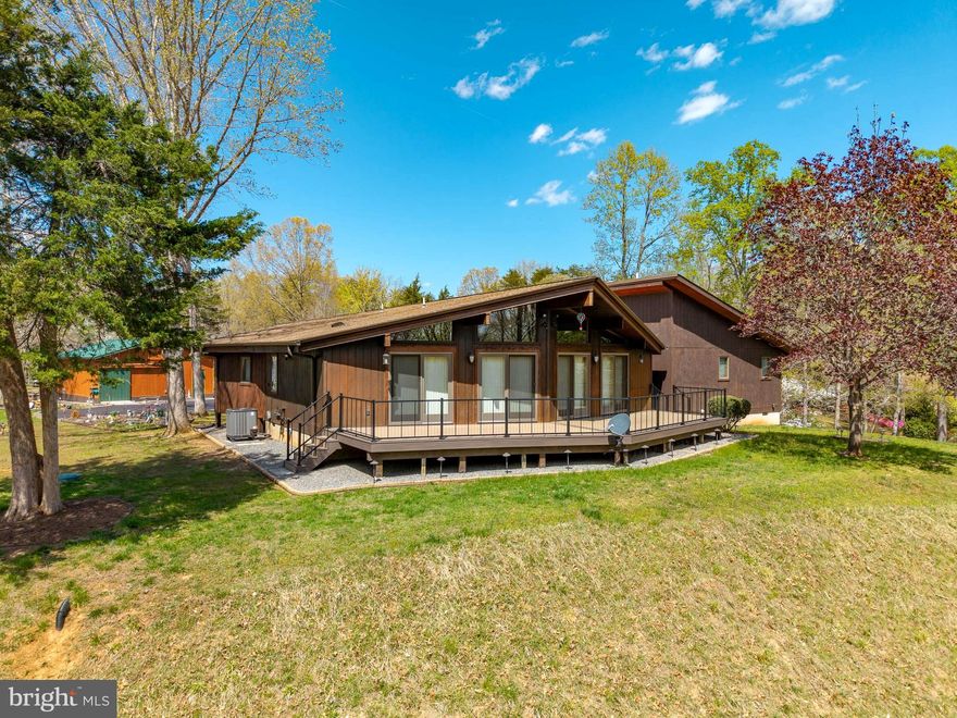 Welcome to your everyday escape at Lake Anna. This isn't your average, cookie cutter home - this one is truly unique and gorgeous!  A rare opportunity to own a private, multi-structure property near Lake Anna offering space, flexibility, and lifestyle in one package. 
Tucked on a beautifully wooded 2.48-acre corner lot, this distinctive contemporary home offers privacy, flexibility, and a lifestyle that feels like a retreat—without sacrificing convenience.  From the moment you arrive, the setting stands out—mature trees, a paved drive, and meticulously cared for landscape that feels intentional and welcoming. Unique contemporary architecture with warm wood exterior, Expansive windows bringing in natural light and wooded views, Large rear deck offering seasonal lake views ideal for everyday living and entertaining, Open-concept main living area with seamless indoor/outdoor flow...This is a home designed for living well. 
 Situated and set back on a spacious and open corner lot, the property offers 2.48 acres with a park-like setting, Multiple outbuildings for storage, hobbies, or workshop space, Plenty of parking with a large paved driveway and detached garage, Room to expand, garden, or create your own outdoor oasis.

If you have been waiting for the right Lake Anna home that offers all you need for lake living without the waterfront price, you will love it here! this property delivers. Easy access to Lake Anna amenities without waterfront pricing. Showings by appointment. Let's get you home...to Lake Anna!