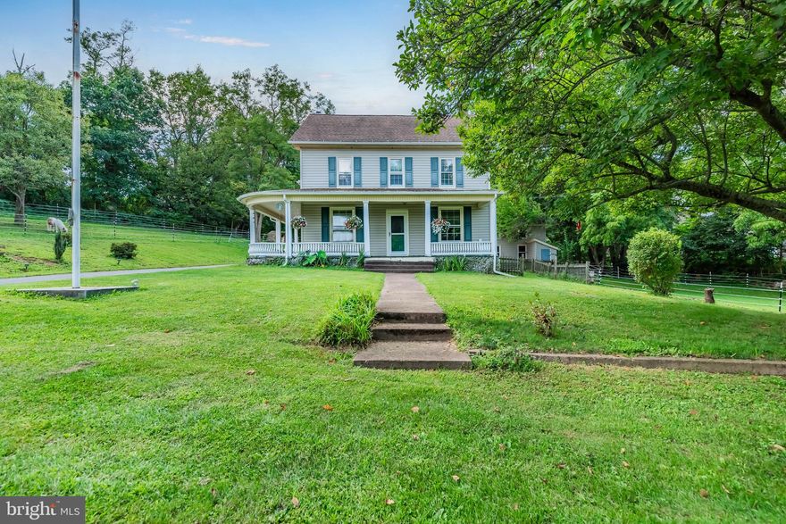 This charming Farmhouse on almost two acres is a must see.   Beautiful views and serene.  Large wrap around porch and back patio.  Two stall horse barn for the horse lover! Barn also has upper level for storage of hay. Electric fence around property, basketball court, and chicken coup! The carriage house has endless possibilities. Home has two levels with outside entrance to a basement. Large staircase leads up to spacious upstairs and hardwood floors throughout. So much charm. This large farmhouse has a newer chimney liner, pellet  stove, boiler and electric box.  Call today for your personal showing!