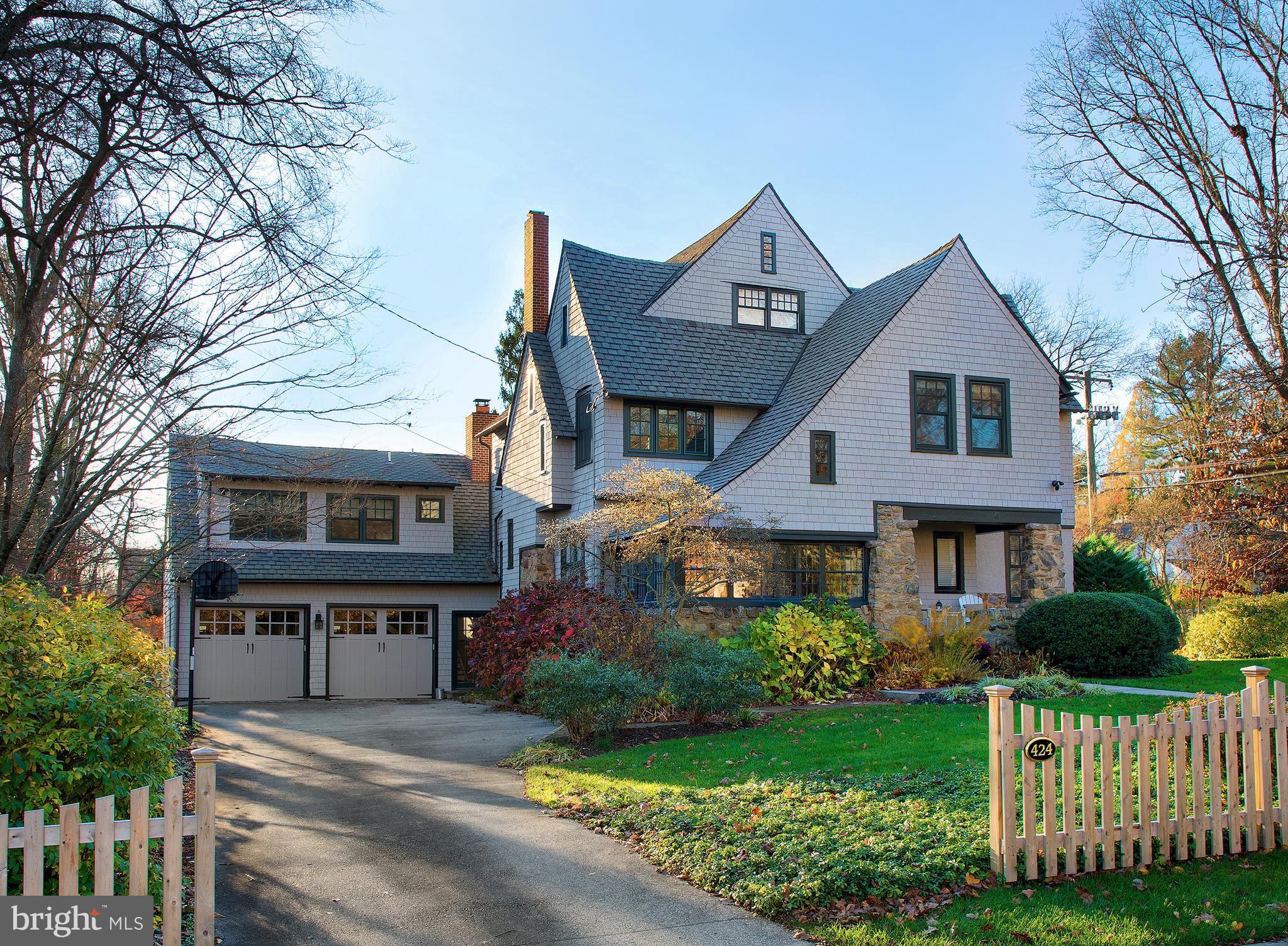 Experience the charm of this stunning 5 bedroom, 4.1 bathroom home on .77 landscaped acres in a prime walk-to-Wayne location! Make this gem yours and enjoy the comfort of its gracious rooms, the elegance of its classic details, and the allure of its many modern updates that include renovation of all bathrooms. The spacious Victorian-style colonial is warm and inviting with a welcoming center hall, lovely moldings, rich refinished hardwood floors, and wide openings to generously-sized main rooms. Relax with family and guests around the wood-burning fireplace in the living room. Serve coffee or cocktails, or sit quietly and read a book in the light-bathed vaulted sunroom. Share meals and celebrate occasions gathered around the table in the spacious formal dining room. Cook up delicious meals in the bright and beautiful updated kitchen featuring abundant cabinetry, ample marble counters for prepping, stainless steel appliances by Sub-Zero and Dacor, a walk-in pantry and bar area, counter with seating, and open breakfast room. Adjoining is a fabulous family room with a wall of built-ins encasing a stone gas-burning fireplace, vaulted beamed ceilings, and reclaimed random-width wood floors. Glass-paneled French doors lead out to the wonderful deck that overlooks the expansive and peaceful level yard. A convenient powder room, and mudroom accessing the attached 2-car garage complete the home's main level. Ascend a small staircase to a vaulted open loft area, perfect as a game/media room, playroom, sitting room, great as an au pair suite, or an office/home theater which it's currently utilized as. Nearby sits a full bathroom. Reached via main staircase is the 2nd story offering 4 bedrooms, 2 full baths with connecting shower, and a washer-dryer. Floor 3 houses an amazing vaulted-ceiling bedroom and full bath with soaking tub and stall shower, now used as the primary suite. Storage is excellent, with a walk-in closet and additional large closet in the bathroom. The part-finished, fully-carpeted lower level has lots of recreation and storage space. Plus with full surround sound, 3-zone HVAC with Nest thermostats, security system, Ring doorbell & exterior floodlights, and a prime address near the train, shopping & top-rated Radnor schools, this is the one!