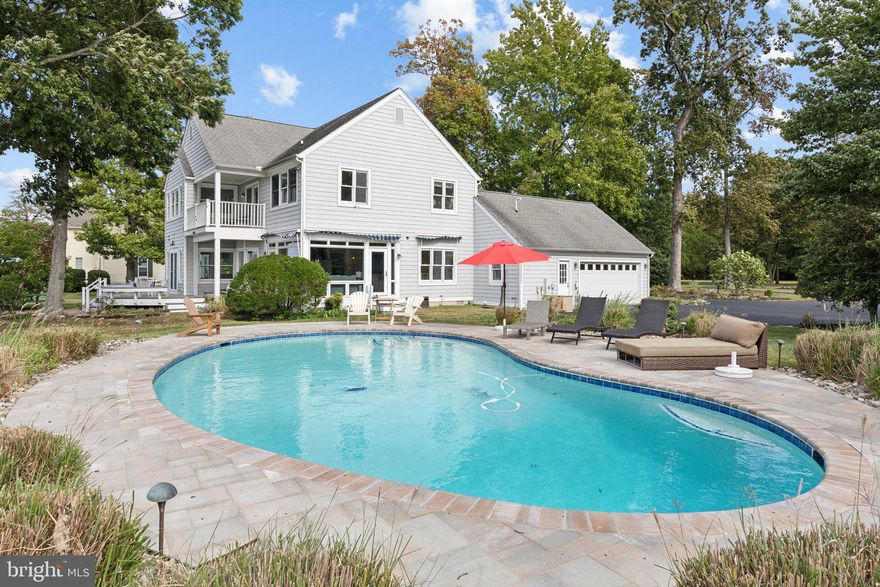 Welcome to your personal paradise nestled on the tranquil shores of the Chesapeake Bay. This stunning waterfront home boasts breathtaking western-facing views, allowing you to bask in the vibrant colors of sunset over the water each evening. Set on an expansive 1.53 acres of meticulously landscaped grounds, this property is located on one of Queen Anne’s County’s most exclusive streets, surrounded by nature's beauty and wildlife, including majestic bald eagles, playful dolphins, and the occasional deer wandering by.
The home features an exquisite coastal design with open spaces and high ceilings, creating an airy atmosphere perfect for entertaining. Enjoy seamless transitions between indoor and outdoor living with ample entertaining areas that invite the beauty of the outdoors in. Dive into summer fun with your own heated waterfront pool, or take advantage of the private pier equipped with a boat lift and lower platform, making it easy to launch your kayak or paddleboard. Experience spectacular views of the iconic Bay Bridge and Bloody Point Lighthouse, with the western shore just a short boat ride away. Indulge in dining adventures at local eateries across the bay in Annapolis and West River or explore the charming destinations of Kent Narrows and St. Michaels to the east. For your everyday needs, a quaint country marina store is just around the corner, offering essentials for quick meals, as well as delicious takeout options, including steamed crabs and a selection of seafood, beer, and wine. This property is the epitome of Eastern Shore waterfront living, where luxury meets nature, and every day feels like a vacation. Come and discover the ultimate retreat that awaits you on the Chesapeake Bay!