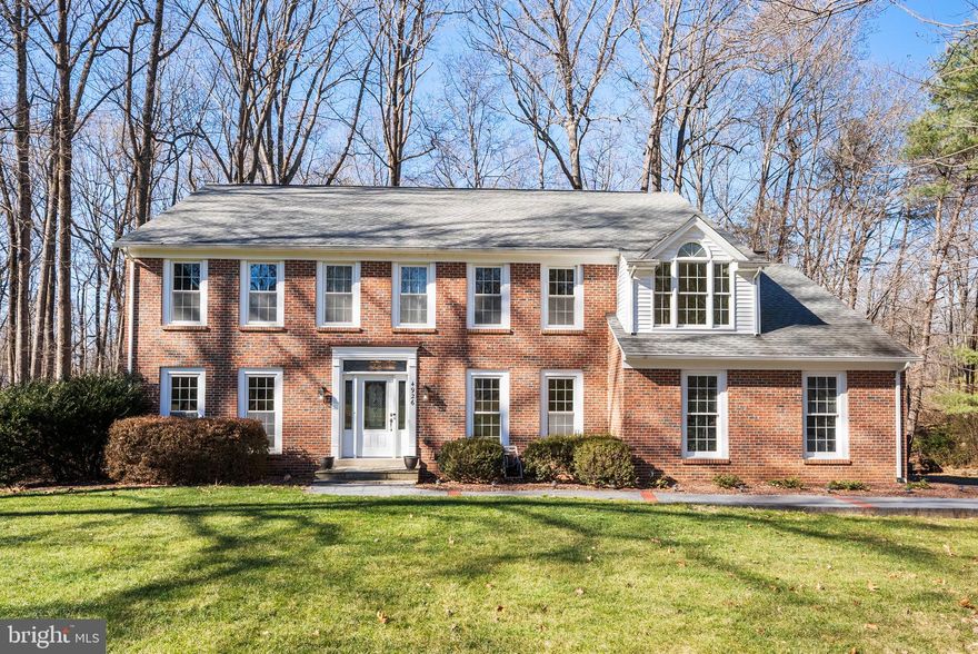 Welcome home to this stately updated and well-maintained colonial, set on nearly 2 private acres in a quiet cul-de-sac and backing to beautiful wooded parkland. A large two-story foyer welcomes you, with a private home office just off the entry. Designed with entertaining in mind, the ideal floor plan flows beautifully from room to room. The gourmet eat-in kitchen features custom cabinetry, quartz countertops, stainless steel appliances, and a double wall ovens, with a large bay window offering peaceful woodland views—an ideal spot to enjoy your morning coffee. The kitchen opens to the expanded, light-filled family room with hardwood floors and a cozy brick wood-burning fireplace, plus access to a spacious deck for indoor-outdoor living. The main level also includes a dining room conveniently located off the kitchen, a formal living room, a powder room, and a large laundry/mudroom with access to the two-car garage.
Upstairs, you’ll find four generously sized bedrooms and three full baths, including two en-suite bedrooms. The luxurious primary suite boasts a large walk-in closet and a spa-like, updated bath with dual vanities, soaking tub, spacious walk-in shower, and heated floors. A second expansive en-suite—part of a thoughtful addition—features a sitting area and private bath. The additional bedrooms are well sized, including one with a sitting area, and share a full hallway bath with dual sinks.
The finished lower level offers brand-new carpet, a bonus room with closet ideal for guests, a full bath, and a large recreation room perfect for movie nights, play space, or a pool table. An additional hardwood-floored platform creates the perfect yoga or fitness area, while the utility room includes a workshop and abundant storage. Outdoors, the private backyard oasis invites relaxation on the deck or patio while enjoying the natural beauty of the surrounding trees and parkland.  Ideally located for commuters and everyday convenience, this home is just minutes from US Routes 29, 50, I-66, and the Fairfax County Parkway, offering easy access throughout Northern Virginia and beyond. Enjoy being only minutes from Wegmans, popular restaurants, and everyday shopping, with Fair Oaks Mall just 5–10 minutes away for premier retail and dining.  Situated within the Woodson High School pyramid—this exceptional home truly has it all.