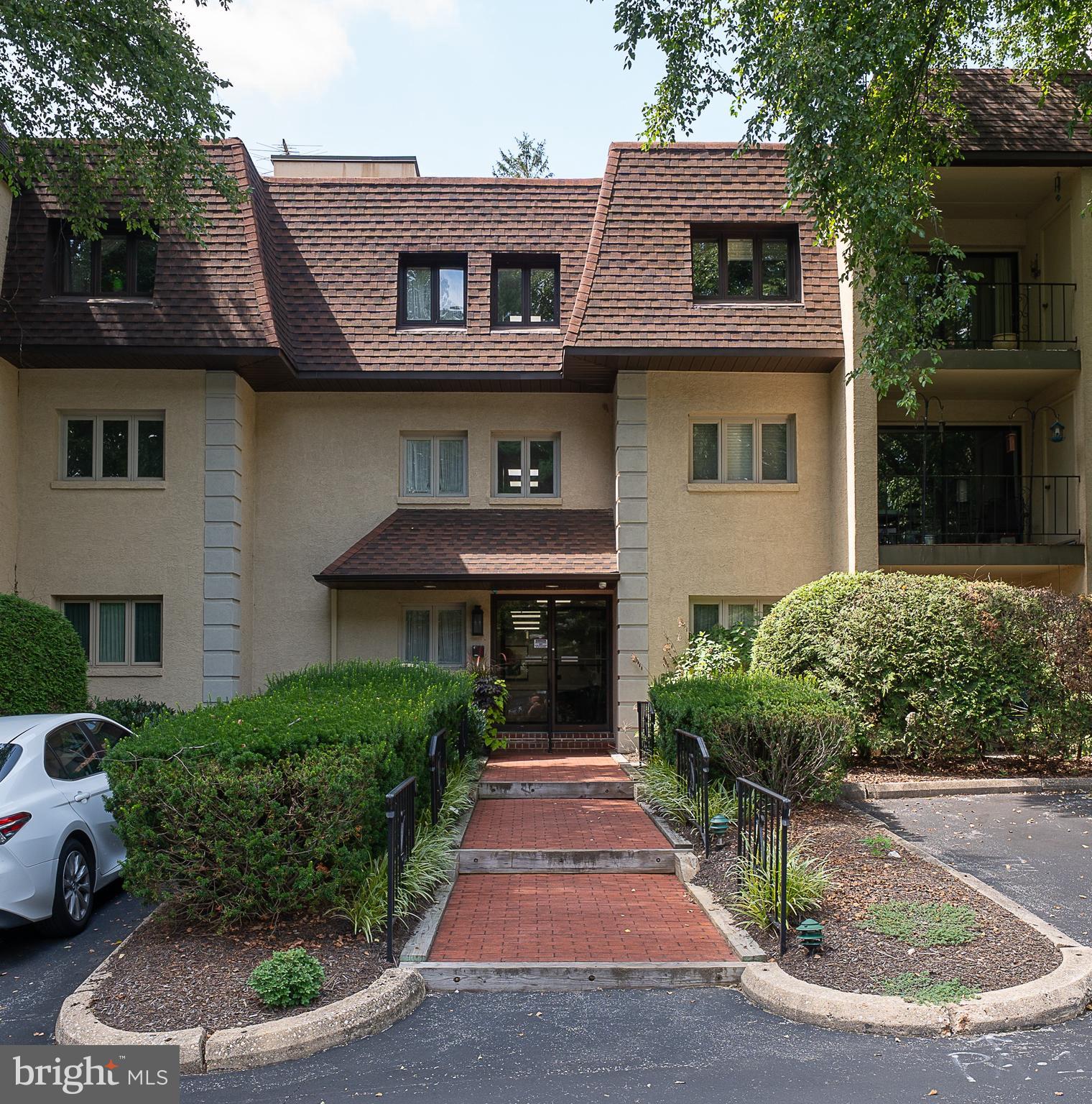 A two bedroom first floor flat for you to move right in to the highly desirable Millridge community. This unit has been carefully maintained and is freshly painted. The bright living area with hardwood floors boasts a balcony with an upgraded Anderson door. It overlooks a wooded setting that provides a private, year round outdoor space. The adjacent dining area opens into a galley kitchen with upgraded appliances and a breakfast counter for additional prep space or to enjoy a quick meal. The hallway leads to a laundry room with full sixed washer and dryer and a hall bath with tub/shower combination, just across from a well proportioned secondary bedroom. The Primary bedroom sits at the end of the hall with a very large walk in closet. Windows on two walls provide sunlight throughout the day. Andover House sits at the end of the property in a very private setting with little traffic. It is just steps from the gated community pool and the wonderful, original Manor House. The Manor is used for meetings and is available for private parties and has guest suites for your out of town family and visitors. Your assigned parking space is just steps from the side entrance that leads to your unit's door. It's First Floor location provides easy access for you and your visitors without the need for an elevator, or flights of steps. This unit has TWO large, assigned bins in the basement storage area for your overflow items. The Millridge community is meticulously maintained and is conveniently located just minutes from dining and retail establishments in Bryn Mawr, Villanova and Newtown Square. Make an appointment today to see this gem in person!