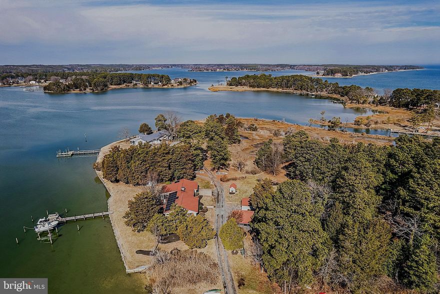 Experience the beauty of Southern Maryland waterfront living with abundant property amenities for ultimate enjoyment of a retreat on Saint Jeromes Creek and the Chesapeake Bay. The water views and setting are exceptional, with an excellent view of the water upon entering the open floor plan of the home, as well as the primary bedroom suite accessing the adjoining hot tub with pergola overlooking the water, and the large four seasons waterside room providing flexibility. The 4.36 acre property features expansive frontage on the creek with a pier offering an 8000 lb boat lift, jet ski lift, electric, water, and lighting. An additional recently updated  cottage can be used as guest or extended family space, as well as for rental income. There is great vehicle and boat storage in the attached 2 car garage and additional 2 car carport, as well as three storage sheds. Also offered is a large workshop with electric. Improvements to the property are a new septic system, new HVAC 2025, roof replacement in 2015, solar panels in 2016 and a  water conditioning system.  In addition to the water activities, there are many other great things to do in the area – restaurants, historical sites, parks, charming Solomons and Leonardtown, nearby Virginia and Maryland wineries, and more. This very special getaway is convenient to the metro area and presents many opportunities having the essentials for a variety of flexible uses.