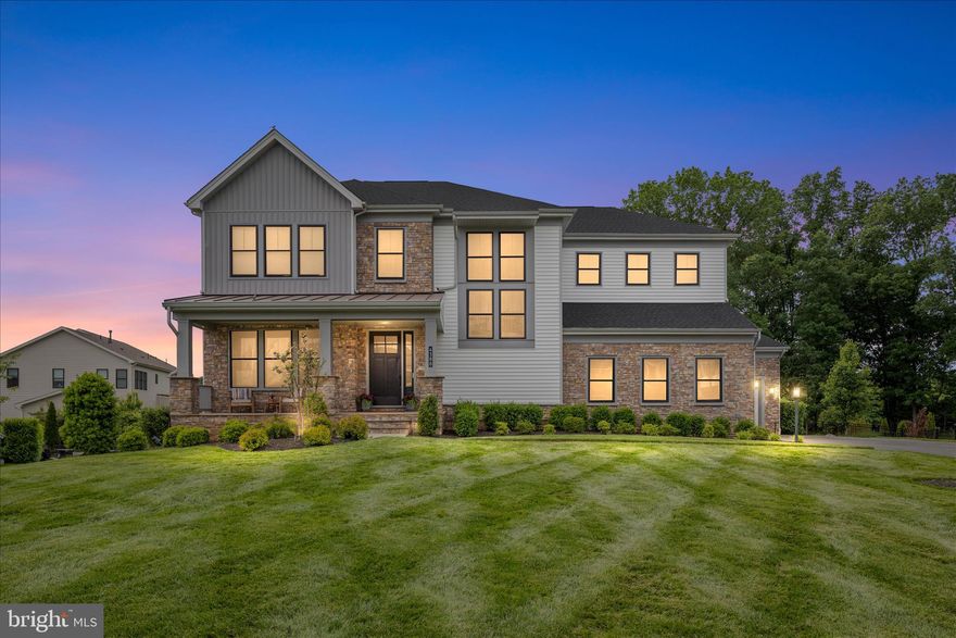 **Open House Sat 4/25 & 4/26 2-4PM**Priced at Appraised Value**Over $470K in Upgrades & Improvements!**See Upgrades & Improvements List in MLS Documents**
Welcome to 4388 Despain Place, a truly exceptional modern farmhouse in the prestigious gated community of Dominion Valley Country Club. Built by Toll Brothers and one of only 16 highly sought-after Reston models in the neighborhood, this home offers a rare opportunity to own a distinctive residence that seamlessly blends elevated design, everyday functionality, and resort-style living. This well-appointed home, built in 2019, showcases a contemporary architectural style with clean lines, refined trim, steep gables, and striking metal roof accents. Perfectly positioned on a private 0.73-acre cul-de-sac lot, it offers over 6,100 square feet of thoughtfully designed living space, ideal for both grand-scale entertaining and comfortable everyday living. From the moment you arrive, the inviting front porch and striking black windows set the tone for the sophisticated style found throughout. Inside, soaring 10-foot ceilings on the main level, solid wood doors, wide-plank engineered hardwood flooring, and a light-filled open floor plan create a seamless flow. At the heart of the home is the expansive gourmet kitchen, featuring a dramatic quartz island with seating, stacked cabinetry, designer tile backsplash, gas cooktop with stainless steel hood, under-cabinet lighting, and a picture window overlooking the backyard oasis. A fully renovated walk-in pantry with custom built-ins, quartz counters, and a beverage refrigerator keeps everything organized, while the butler’s pantry connects effortlessly to the elegant formal dining room with a tray ceiling and crown molding. The family room offers a warm yet refined gathering space with a gas fireplace and a dramatic sliding door system that opens to a two-story outdoor living area complete with retractable screens and tile flooring, creating the ultimate indoor-outdoor experience. Additional main-level highlights include a stylish mudroom with custom built-ins and a private office with glass doors, ideal for a guest suite or multi-generational living. Upstairs, a spacious loft provides additional living space, while the luxurious primary suite, accessed through a niche entry, features a tray ceiling, abundant natural light, and a spa-inspired bath with a freestanding soaking tub, oversized frameless glass shower, dual vanities, and exceptional storage. Secondary bedrooms are generously sized with custom closet systems, including a private en-suite and a thoughtfully designed shared bath with separate vanity areas, and the upper-level laundry room adds convenience. The fully finished walk-out lower level is designed for versatility and entertaining, offering a large recreation area, a fully equipped second kitchen with granite counters and full-size appliances, a fifth bedroom, full bath, walk-in pantry, and additional storage. Outside, the private backyard retreat features a custom in-ground gunite salt water infinity edge pool with a sun shelf and heater,  an expansive paver patio, hot tub, and multiple gathering areas, along with a built-in stone wood-burning fireplace and professional landscaping that enhances privacy and beauty. Additional highlights include a three-car garage with a storage lift system, extended driveway, Tesla charger, solar panels, whole-house surge protector, and water softener. Residents of Dominion Valley Country Club enjoy access to a championship golf course, renovated clubhouse, fitness center, indoor and outdoor pools, tennis and pickleball courts, scenic trails, and more, all conveniently located near major commuter routes, shopping, dining, wineries, and breweries. This is more than a home. It is a lifestyle.