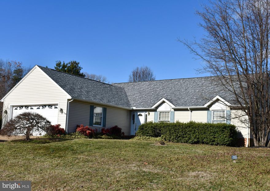Spacious one-level living in convenient, non-HOA community.  Custom-built to be "just a little bigger," with a wide foyer with cathedral ceiling, housing a powder room and walk-in coat closet.  A 48" hallway leads to the bedrooms.  Each full bath has a linen closet, and there are two in the main hallway.  Don't forget to notice the attached two-car garage off the laundry/utility room, which is off the kitchen.  Cathedral ceilings soar in the open living area and owner's suite.   The large kitchen with ample counter space boasts both an island and breakfast bar, besides an extra spot for either a second refrigerator or freezer.  Seller knows you'd like to replace carpeting and kitchen/bath flooring and pick out your own paint colors, so he's priced aggressively for that.  Home is sited on a corner lot with over a third of an acre of professionally-designed landscaping, with aggregate driveway, patio and sidewalk.