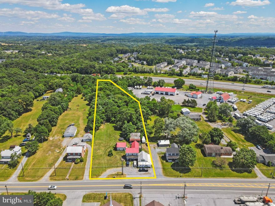 AVAILABLE NOW! 2.74 Acre Lot with Route 11 Frontage in Falling Waters West Virginia, Close to Maryland State Line. Property Backs to I81. Currently has a two story home, with small commercial store front attached (previously operated as a day care), and a detached garage converted into an apartment. Potential uses could be home seperated into apartments, car lot, mini storage, RV parking, and many other uses. Call For Details.
