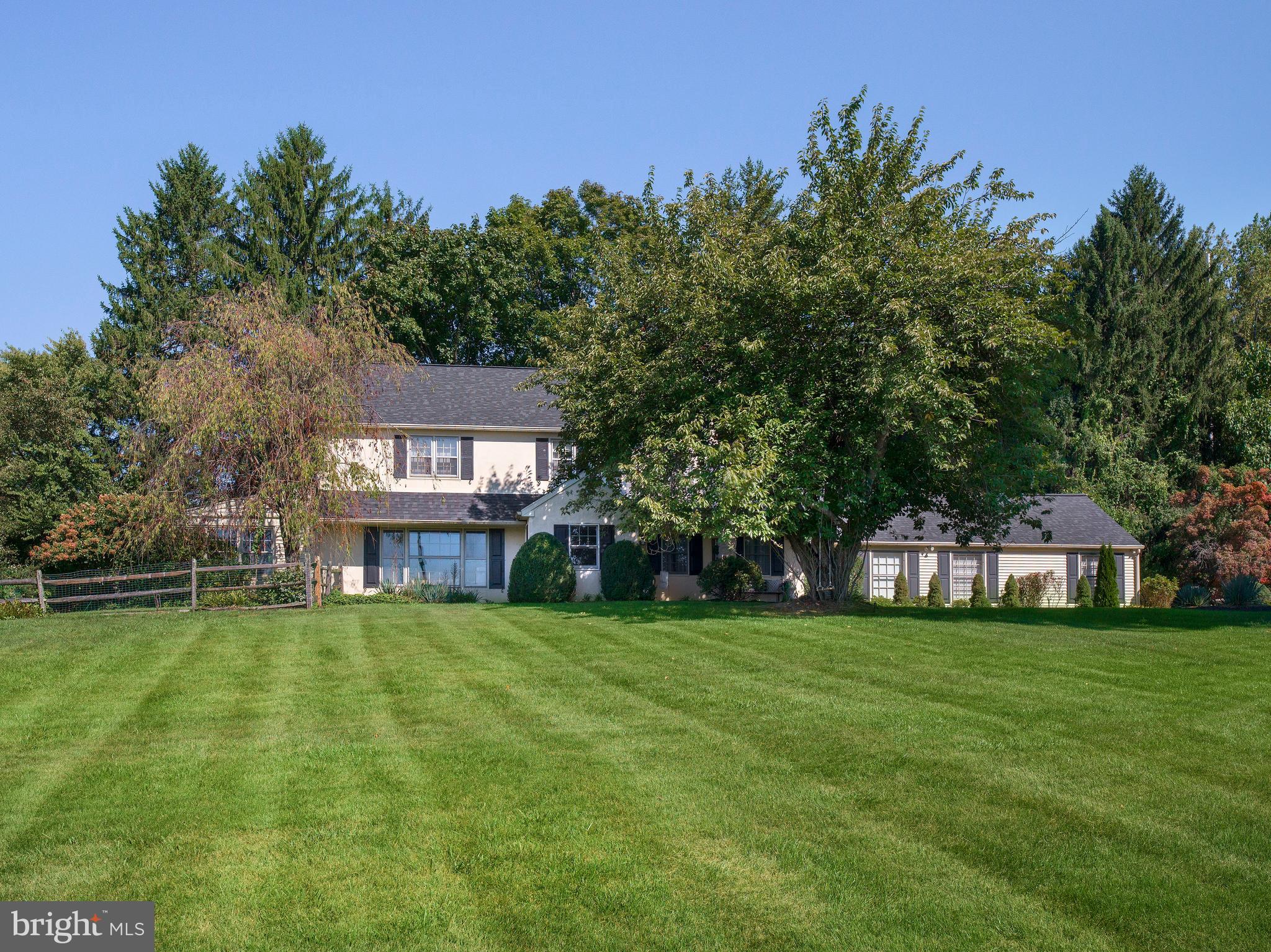 Perfectly positioned on a picturesque corner of a quiet cul-de-sac and set on over an acre of beautifully landscaped property, this exceptional home offers sweeping front-facing views of the 15th and 16th holes of the prestigious Waynesborough Country Club. From your front yard or through expansive windows, enjoy the rare luxury of watching the golf course’s annual fireworks display—twice a year—from the comfort of your own home.
A long driveway leads to a spacious two-car detached garage with ample room for additional parking—ideal for hosting gatherings or accommodating multiple vehicles. The backyard is fully fenced and offers complete privacy, enhanced by mature landscaping that surrounds the property and creates a peaceful, park-like setting. Whether lounging by the inviting pool, relaxing under the pergola, or enjoying the covered patio, the outdoor spaces are designed for comfort and entertaining.
Inside, a light-filled open foyer welcomes you into the home. The front living room is bright, spacious, and perfectly positioned to take in the stunning golf course views through oversized windows. Off the living room, a sun-drenched sunroom—currently used as a billiards room—opens to the rear covered porch, creating a wonderful indoor-outdoor flow. Also off the living room is a home office featuring custom built-ins and peaceful views of the backyard, ideal for remote work or creative pursuits.
The thoughtfully designed kitchen is both stylish and functional, featuring stainless steel appliances, quartzite countertops, and plenty of room for a large dining table. A gorgeous stacked-stone wood burning fireplace adds warmth and charm, making this space the heart of the home. The kitchen seamlessly connects to a generous dining room, ideal for entertaining, and a dedicated bar area, perfect for celebrations and casual evenings with friends.
Down the hall, the expansive great room offers a flexible layout with space for both cozy furniture and recreational activities. A first-floor bedroom with a large ensuite bathroom provides an ideal guest suite or in-law option. The main level also includes a powder room for guests and a spacious walk-in laundry room, conveniently located for everyday ease.
Upstairs, the owner’s suite is a true retreat with raised ceilings, abundant natural light, and an expansive custom walk-in closet offering exceptional storage and organization. The ensuite bathroom is elegantly appointed with double vanities, a soaking tub, and a large walk-in shower. Down the hall, another bright and comfortable bedroom with its own ensuite bath offers privacy and convenience. A unique two-story bedroom suite features a main-level living space and a lofted bedroom above, offering a creative and flexible layout. A recently updated hall bathroom serves the upper level.
Throughout the home, hardwood and tile floors add warmth, style, and durability. Every room in this property was designed with comfort, function, and beauty in mind.
This one-of-a-kind home combines an extraordinary location with thoughtful design, total privacy, and inviting outdoor spaces—making it the perfect retreat, just minutes from everything the Main Line has to offer.