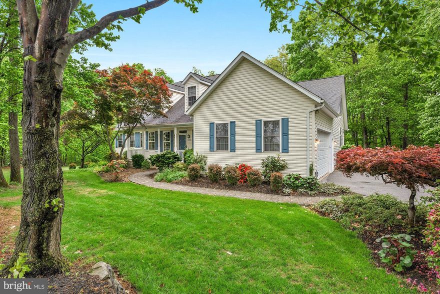 Set back behind a wooded tree line on 1.14 private acres in Hampstead, this custom-built Colonial is the kind of place families grow into and never want to leave. Nearly 5,000 finished square feet across three levels, with a total footprint pushing 5,638 square feet. Professionally cleaned and repainted top to bottom, the next family walks in on day one to something fresh and move-in ready. The yard is open, usable, and exactly what you have been looking for, with mature trees providing natural privacy on one side and a massive deck overlooking the backyard on the other. The kind of deck where summer happens, the grill runs all weekend, and evenings stretch longer than they should because nobody wants to go inside. A storage shed is already on site. Step inside to a custom office with glass French doors on your left and a formal dining room on your right. The great room is the true centerpiece, with vaulted ceilings, an open second floor, and one of three fireplaces anchoring the space. It flows naturally into a casual dining area and breakfast nook before connecting to the kitchen. The kitchen was built for people who actually cook. A Pro-Style Jenn-Air cooktop with four gas burners and a built-in indoor gas grill, a Frigidaire Gallery double convection wall oven, a stainless steel range hood, a center island, and a massive dedicated pantry. An owned and buried propane tank means no rental fees, no contracts, no hassle. The oversized two-car garage is fully repainted and finished with an electric door opener.
Downstairs, a finished rec room with a wet bar and third fireplace handles game nights, movie marathons, and playoff Sundays with ease. A flex room, dedicated wine cellar, and separate walkout sit behind it. A fifth bedroom and full bath make this one of the better in-law suite setups you will find at this price point.
Upstairs, three oversized bedrooms each feel like a genuine retreat, including one with its own en suite and a bonus unfinished room ready to finish into whatever your family needs. The primary suite has its own wing on the main level, complete with a step-in shower, soaking tub, and two walk-in closets. Five bedrooms, four full baths, a half bath, and three fireplaces. Infrastructure highlights include a new water heater (March 2026), dual heat pump systems (upper 2023, lower 2020), dual 225-amp electrical panels, an ecobee smart thermostat, a hardwired GE security system, and a full well water treatment and filtration system. Quick access to Routes 30 and 140, with I-795 connecting you to Baltimore and the beltway. Served by Hampstead Elementary, Shiloh Middle, and Manchester Valley High. The rural lifestyle without sacrificing the convenience. Schedule your showing today.