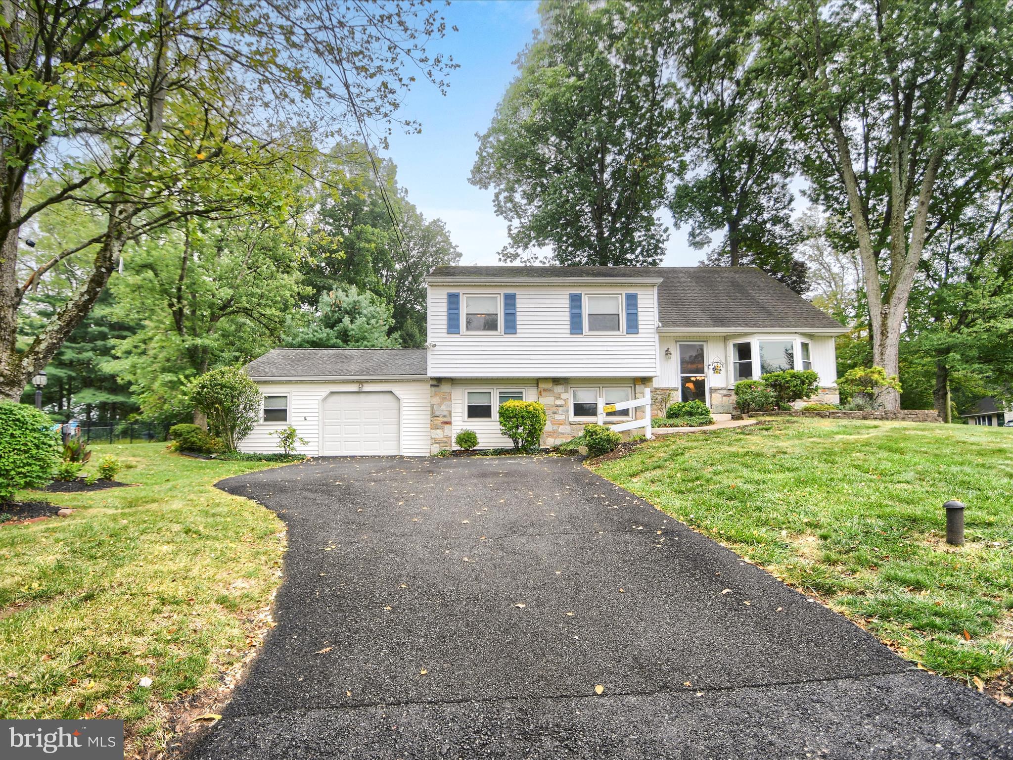 Super Well Maintained Split Level Single with Four Bedrooms, Two Full Baths, One Half Bath. Located in Central Bucks School District and New Britain Township on nearly a full 1/3rd acre lot. Entering into a large living room with hardwood floors and a bay window facing the front, perfect for plants to grow or cats to lay in the natural light. The dining room has access to the kitchen and to the gorgeous paver patio that was just completed in 2022. The kitchen was fully remodeled, with heated floors, granite counters, full pull drawers and soft close cabinets. Two large Lazy-Susans for easy access, pull out spice rack for cooking. Tile backsplash featuring Mercer tiles of the seasons. The seated counter has room for three or four. Upstairs are 3 large bedrooms and a full bath. The Primary Bedroom has a large closet and a renovated full bath with tile shower and heated floors. The 3rd floor has a massive 4th bedroom that could double as a play space or an office. On the lower level is a huge 24X22 family room completed with a half bath and access to the crawl space that was professionally water-proofed and installed with a commercial dehumidifier for peace of mind. As an improvement the floor joist under the kitchen were extra supported to guarantee minimal settling. The laundry room has a gas dryer and washer machine, new gas hot water heater (2023), hot air furnace and central A/C with 3 year warranty remaining. The garage has one door but is extra wide for storage or workshop space. The new cambridge paver patio is perfect for quiet enjoyment at all hours, right beside the shade garden under the mature trees, planted with perennials . Home includes tons of features and improvements in the attached documents. Some of which are a electric panel switch for hooking up a generator to run essential circuits. A home security system. Gutter Guards front and back. New garbage disposal (2025). Don't miss this great opportunity!