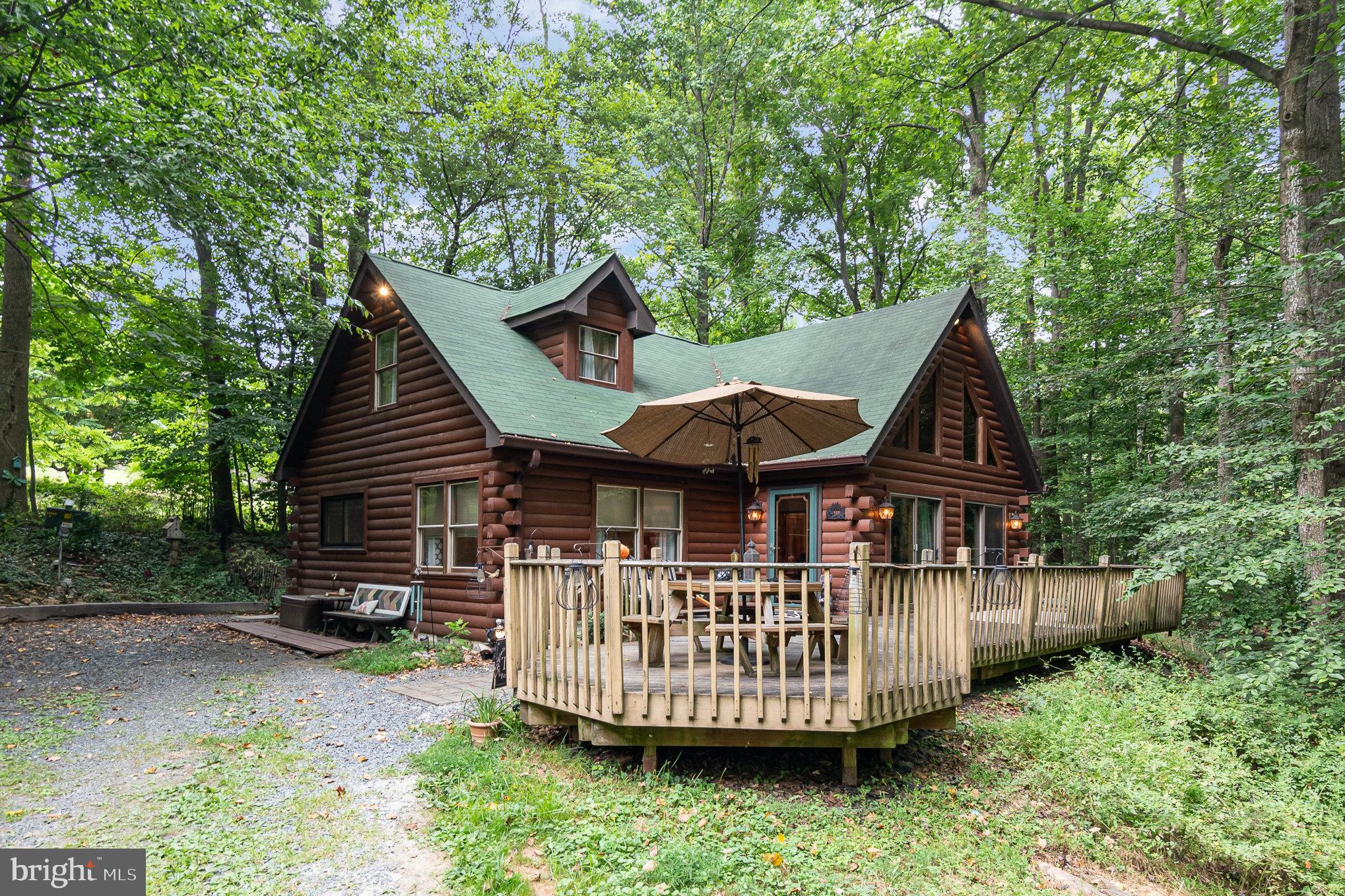 Welcome to this gorgeous Log cabin retreat on over an acre of woodland within literal walking distance of Bel Air. This is a one of a kind opportunity to be in a remote gorgeous setting full of wildlife while only steps away from downtown Bel Air. The outdoors here are a dream from the fire pit area tucked in the woods near the foot of the driveway, to the stream running through the front yard and under the driveway with two different sets of steps walking down to it, to the trails that lead back into the forest, and the rock gardens and swings, and sheds and the list goes on.This property is on city sewer and private well with a water filtration and softener system. The roof is only 4 years old, there is a deck that wraps around the front of the house and overlooks the stream and forest. The landscaping is rustic and cozy. Inside the home has been updated, with a large family room with high vaulted wooden ceilings, and a stone work fireplace, and spiral staircase leading to the second floor. The formal dining room has a decorative custom cieling, the country kitchen has granite countertops, an island, backsplash and stainless appliances. There is main floor laundry just off the kitchen, a powder room and first bedroom. There is a main floor owners suite with a large walk in California closet, and a large fully modernized owners suite bathroom with linen closet, double vanities, tile flooring and a walk in tile shower. Upstairs are two more bedrooms and a full bath and tons of closet spaces. The outdoor storage shed is wired for electric. Wow, this is a one of a kind retreat, waiting for you!
