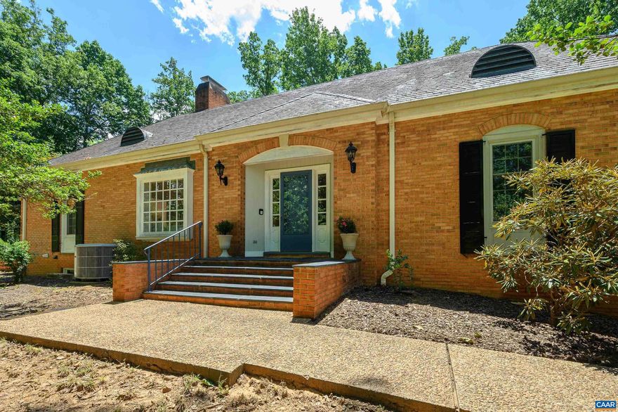 Beautiful, sprawling brick home w/ slate roof located in the highly desirable Ednam Forest neighborhood. Architectural details throughout, such as pocket doors,  built-ins & dental moldings. Flooded w/ light, this home has hardwood floors on the main level, and soaring ceilings. The spacious living room has a beautiful wood-burning fireplace and picture frame window. The den, which is off the living room has a full bath, and could be used as an office, or a 4th bedroom.The four-season sunroom makes a cozy spot for reading or evening cocktails.  First-floor primary bedroom w/ bath, and walk-in closet. The large dining room and kitchen make perfect space for dinner parties and entertaining.The Kitchen has ample counter space,an island, dumb waiter, & breakfast area. Several doors on the first floor lead out to the large brick patio.  There are two bedrooms upstairs, both with ensuite baths. The large basement could easily be finished and turned into a gym, playroom. or flex space. Incredible opportunity for a buyer to renovate this home and make it really spectacular. Minutes from Boars Head Resort, and Sports Club. Walking Trails right in your backyard which lead to Round Top and The Reservoir.