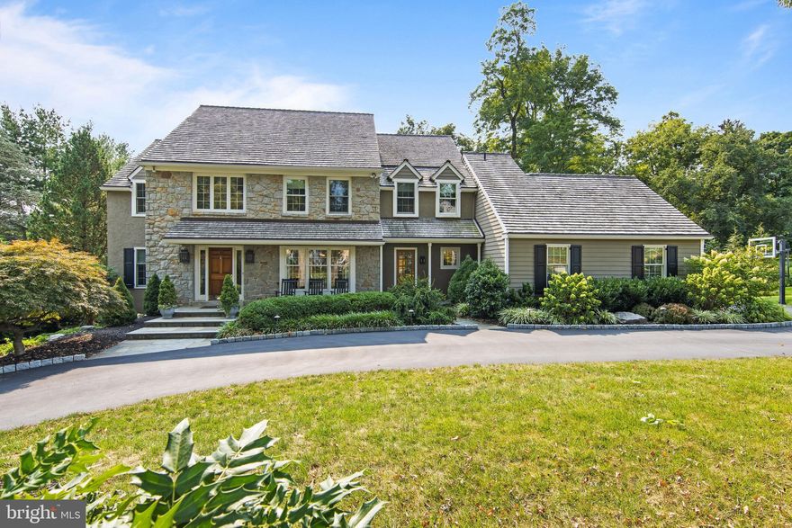 The home you’ve been waiting for… with over $200,000 in upgrades since 2014! Beautiful 4-5 BD, 4/1 BA colonial home in the sought-after community of Ravenscliff in Wayne. This home is sited in a premier location, in the inner loop of a quiet, no-through-traffic neighborhood, on a picturesque, level .60 ac. lot. Soaring 2-story Entrance Hall opens to a gracious formal Dining Room with enhanced millwork, wainscoting, and two chandeliers. The inviting Living Room, with new built-ins and a marble fireplace with gas logs, is also open to the Foyer, and features two sets of French doors to the rear deck. Nearby is a secluded Office/Study, with more built-ins, and a recently remodeled Powder Room. Enjoy relaxing in the vaulted Family Room, with a distinctive arched window, beamed ceiling, built-ins, and floor-to-ceiling stone fireplace with gas logs. Popular “open concept” floor plan with views from the Family Room to the Kitchen, which has stainless appliances, new quartz countertops, island, separate breakfast bar seating area for 4, as well as a spacious Breakfast Room which opens to a new side patio. The expansive Butler’s Pantry with sink and beverage frig is ideal for entertaining. A large Laundry/Mudroom is located near the side entrance and leads to an oversized 2-car garage. A convenient circular driveway provides ample guest parking.
Upstairs, the Primary Bedroom suite features a huge walk-in closet with custom organizers, a room with a double vanity with radiant heat floors, and separate private room with a large tub, gleaming glass-enclosed shower, and toilet. Two Hall Bedrooms, each with 2 closets, share the attractive Hall Bath, which has a tub and large double vanity. The 4th Bedroom has one closet and an en-suite 3rd full Bath with shower & radiant heat tile flooring. The lower level of this home is larger than many in the neighborhood. It features a Recreation Room, spacious nook for toys and hobbies, a large Exercise Room, and a bright Media Room/5th Bedroom with built-ins and 4th full Bath. This room has glass doors to the rear yard. Two more large unfinished rooms provide ample storage and potential for add’l living space.
Abundant large windows flood this home with natural light. Enjoy scenic views from the expansive rear deck and the large side patio. Professionally landscaped yard, bordered by mature shrubs and trees for privacy. Wonderful location just minutes from shops, restaurants, and train station in the charming town of Wayne. Easy access to Center City, airport, corporate centers, parks, trails, and highly-ranked Radnor schools. Showings start Jan. 19th. Schedule your appointment today!