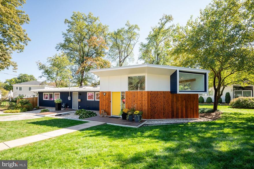 New Price and Open House 11/19 2-4 pm.  Welcome to 3017 Pine Spring, a stunning renovation and expansion by Michael Cook of Cook Architecture in the mid-century modern community of Pine Spring in Falls Church.

The home features a combination of the original footprint with a soaring, butterfly-roof addition encompassing the living room and private primary suite, which cantilevers 3.5 feet off the foundation. The original home was designed by leading mid-century architects Arthur Keyes, Nicholas Satterlee and Chloethiel Woodard Smith.

In 2015, Cook transformed the original 3 bedroom/1 bath 1,060 square-foot atomic ranch into a brand-new modern oasis with 4 bedrooms, 2.5 bathrooms and 2,215 square-feet. The current owners have made a host of improvements including custom built-ins in all closets, installing custom doors on all closets, had hardwood floors refinished, fully fenced the yard, installed custom blinds, including motorized unites in the living room, and furnishing the house with a Nest thermostat. The interior and exterior of the house have been painted within the last two years and the exterior wood siding has been stained. They planted thriving grass as well.

Sited on a .27-acre lot on a quiet cul-de-sac, the home’s design and window placement create a sense of privacy while connecting the interior space with the natural surroundings, including large, mature trees. The home features stone patios in the front and back yards and decks leading to separate owners and guest entrances.

While maintaining some vintage touches such as the exterior wood siding, the home was completely updated with new plumbing, electrical, insulation and low-E insulated, double-paned windows. White oak floors sealed with low VOC matte sealant were installed throughout the house, which has two HVAC zones covering the original part of the house and the addition. Both furnaces and high-efficiency water heaters.

The focus of the home is the open kitchen, dining and living room. The soaring living room addition features exposed structural beams clad in ash, a new powder room and walls of glass while maintaining plenty of wall space for art. Recessed lighting and adjustable art lights have been installed throughout the house.
The kitchen, with its large island with seating for three, features Caesarstone quartz countertops and Kitchen Aid stainless steel gas range and refrigerator, and Viking dishwasher. The back splash is crafted from Royal Mossa tile. Ash wood sheathing houses the white, modernist cabinetry and is used in the hall closets. The kitchen is open to the dining area with gas fireplace, skylights and wall of glass looking out to the backyard stone patio.

The private primary suite includes a full wall of custom ash closets with walnut shelving and clerestory windows to maximize privacy. Hand-made ceramic sconces by New York-based artists frame one wall while a hanging globe light adds a mid-century touch. The master bathroom has a deep soaking tub, glass enclosed shower and double sinks.

In addition to the primary suite, the house has three other bedrooms with good storage space and a renovated full bathroom. All bathrooms are finished with white Italian wall tile and modernist grey porcelain tile flooring.

The exterior of the home is a combination of the restored original wood siding, cement board siding and cedar cut to match the original dimensions. The backyard features a large storage shed, which has been painted. The roof on the original part of the house is tar and gravel while the roof on the addition is a TPO cool-roof membrane that does not absorb heat from the sun.

Pine Spring, the mid-century modern community of 130 homes, is conveniently located inside the Beltway just off Route 50. Three Metro stations are within 3 miles while the Mosaic entertainment district is located just less than 2 miles away.