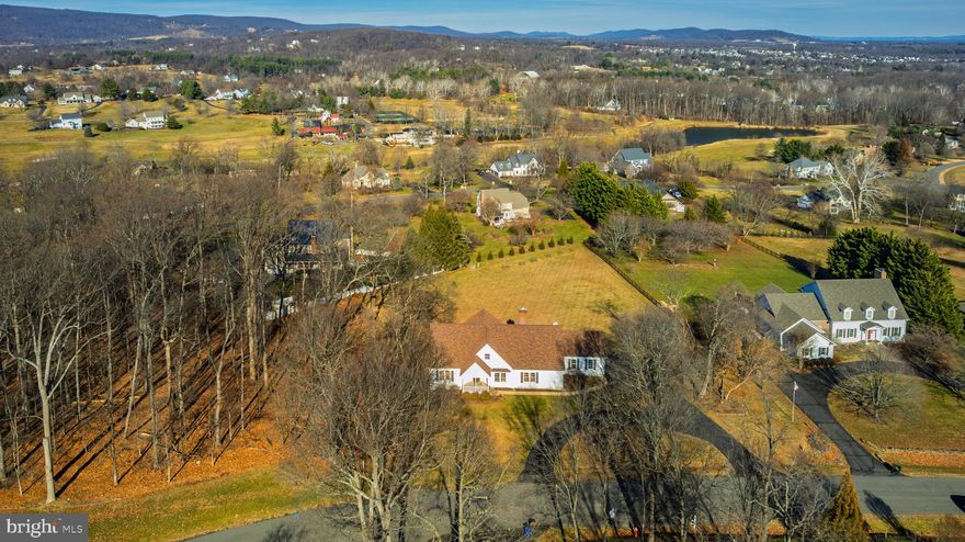 Open house Sunday 1/18th 1-3 pm don’t miss out on this gem!….
Updated rancher in Stoneleigh Country Club with true main-level living! 🏡✨ This beautifully updated home offers over 4,000 square feet with 4 bedrooms and 4 full bathrooms, perfectly positioned on a 1.6-acre lot with breathtaking mountain views, a private wooded backdrop, and an orchard featuring native fruit trees including pears, peaches, and pawpaws. 🌳🍐

Inside, the open and spacious floorplan is filled with natural sunlight. The main-level primary suite features an updated ensuite bath with a frameless walk-in shower, double-sink vanity, and a large walk-in closet with custom shelving. The main level also includes three additional bedrooms—bedrooms two and three share an updated Jack-and-Jill bath, while bedroom four has access to a fully updated hall bath. Living spaces include a stunning great room with vaulted ceilings and a wall of windows showcasing beautiful mountain views, a living room/flex space, a formal dining room, and a cozy den with fireplace off the kitchen—perfect for everyday living and entertaining. 🔥

The home features a brand-new designer gourmet kitchen with white shaker soft-close cabinets, quartz countertops, abundant storage, a classic white subway tile backsplash, and new stainless-steel appliances. Refinished hardwood floors run throughout the main level for a clean and cohesive look, and the kitchen offers space for casual dining with easy access to the formal dining room—ideal for gatherings and holiday celebrations. 🍽️ For added convenience, there is a main-level laundry and mudroom. A beautiful oak staircase leads to the unfinished walk-up attic, offering over 1,300 additional square feet for future expansion.

The finished walk-out lower level with brand-new carpet includes a full bathroom, large recreation room, home office or gym area, and generous unfinished storage, with access to a covered patio—perfect for relaxing and entertaining outdoors while enjoying the peaceful wooded setting. Additional highlights include an oversized side-load two-car garage and a charming horseshoe driveway. 🚗 Recent updates include a new gourmet kitchen, all four fully renovated bathrooms, refinished hardwood floors, fresh interior paint, new carpet, LED lighting, and updated fixtures and hardware. ✨

Located within the sought-after Stoneleigh Country Club, this meticulously updated estate offers access to world-class amenities including a championship golf course, clubhouse, tennis courts, and swimming pool, all set against Loudoun County’s scenic countryside. Ideally situated just 30 minutes to Dulles International Airport, under an hour to Washington, D.C., and minutes to Route 7 for easy access to shopping, dining, and entertainment. ✈️🛍️ With low HOA dues of just $75 per year and the convenience of public utilities—no well or septic—this extraordinary property offers the perfect blend of luxury, convenience, and tranquility. Schedule your private tour today and experience this exceptional home. 📞🏡