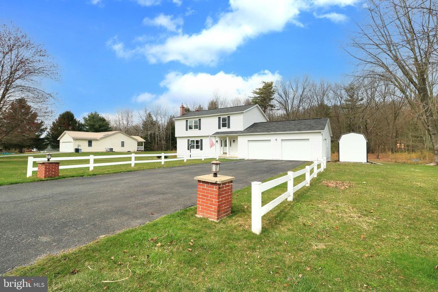 Classic colonial with modern touches on a gorgeous 1.4 acre lot!   This move-in ready home is sure to please with ample living spaces, including a spacious front living room with generous south facing natural light and a large rear family room complete with recessed lights, a Franklin gas stove, a bay window and attached bookshelves.  In between you'll find an open concept kitchen and dining room boasting quartz countertops, a big island with breakfast bar, recessed lights, tiled backsplash, and a new sink and faucet.  You'll love the huge mudroom/laundry room with access to the garage and rear deck & yard, a built-in bench, ample space for pet items/sports equipment/backpacks, etc., plus pulldown storage in the attic above.  Upstairs find three sizable bedrooms with new carpet and two baths, including an owner's suite with a recently remodeled bath featuring a tiled shower.  Have fun in the lower level rec room, which has a connection for a future wood or gas stove.  Enjoy comfort with the new windows (2021) and a heat pump/central A/C system, plus backup hot water heat through the boiler.   Entertain on the spacious back deck under the canopy or relax in the hot tub while taking in views of the gorgeous landscaping and trees in your private and flat backyard oasis.  With an oversized 27 x 28 garage (new doors) and a shed, there is plenty of storage beyond the basement and attic.  Other features include two utility sinks, radon mitigation,  a workbench area in the garage, and ample parking in the driveway.  All this in a peaceful country neighborhood setting with easy access to State College and Altoona.