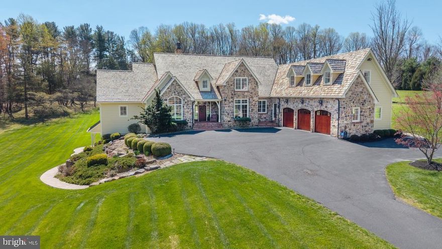 You could wait a lifetime for a home of this caliber to come to market. This one‑of‑a‑kind estate blends extraordinary craftsmanship with modern luxury across 13.98 bucolic acres in Southern Chester County. With more than 7,000 square feet of refined living space, every inch of this residence showcases distinctive beauty, architectural sophistication, and breathtaking views.  Inside, you will find four spacious bedrooms and 6.2 baths, along with the flexibility to create an in‑law or au pair suite with minimal modification. Exceptional millwork, custom finishes, and thoughtful design create eye‑pleasing details throughout.  A dramatic Great Room welcomes you with Black Walnut floors that flow through much of the main level, striking arched wooden ceiling beams, and a stunning wall of windows that frames the natural landscape. The gourmet Kitchen, Butler’s Pantry, and sun‑filled Breakfast Area overlook a resort‑style backyard featuring a saltwater pool, waterfall, fire pit, Pavilion, and expansive hardscaping—an entertainer’s dream.  The main‑level Primary Suite is a private retreat, offering a Sitting Room with wet bar, a cathedral‑ceiling bedroom with a wall of windows, and a spa‑inspired bath. A handsome Office, Mudroom corridor, and full Pool Bath complete the first floor.  Upstairs, three generous en‑suite bedrooms—two with sitting rooms and one with a dedicated workspace—provide comfort and versatility, including the option for an additional Primary Suite. The fully finished lower level expands the living space with a spectacular wet bar, media area, laundry, half bath, and flex space with its own entrance and full bath—ideal for a home business or potential in‑law/au pair suite. The possibilities are endless.  There are simply too many exceptional features to list.  This is a property that must be experienced in person to truly appreciate its craftsmanship, setting, and unparalleled elegance.