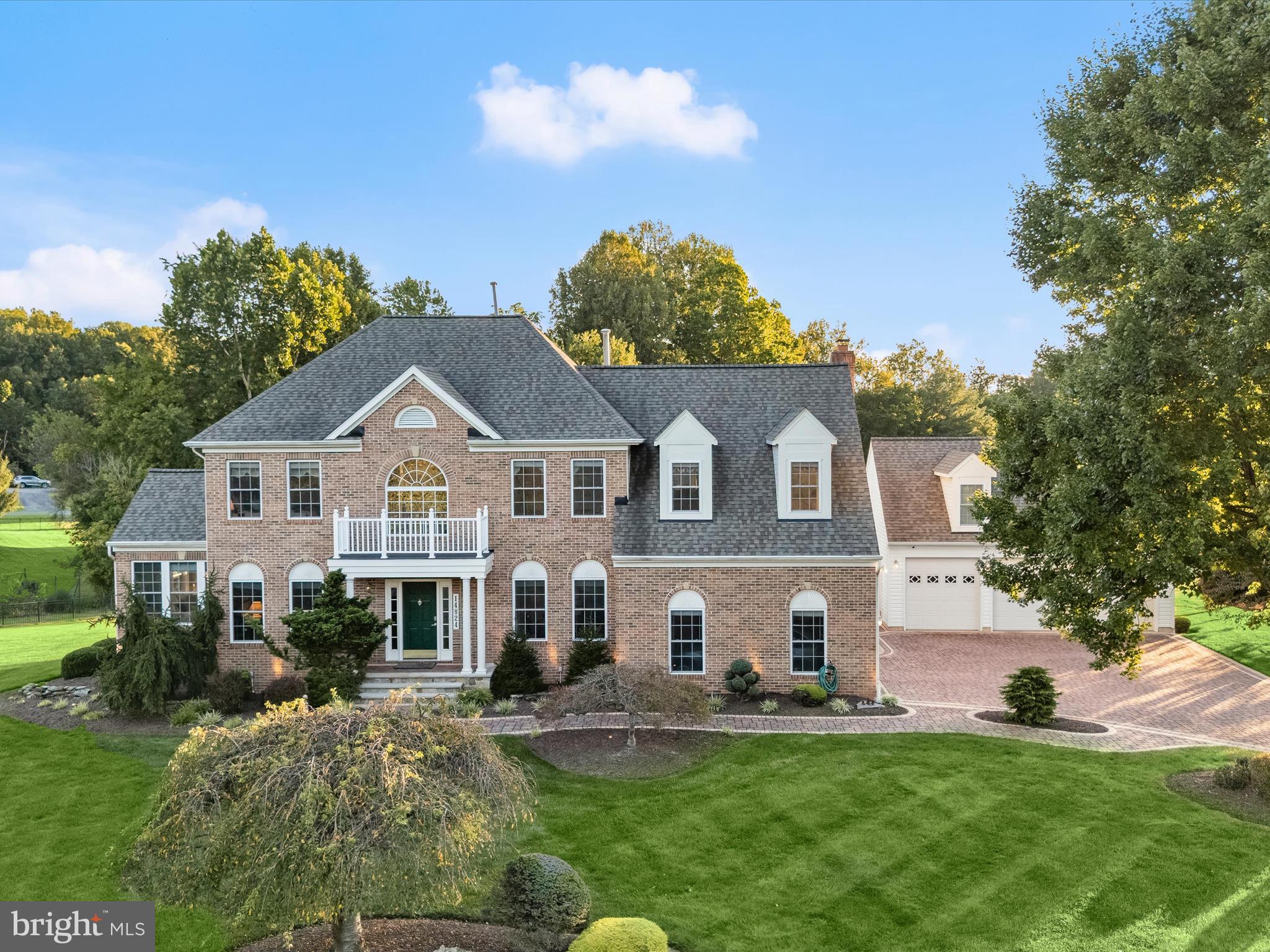 Welcome to this beautifully upgraded estate home in Darnestown Maryland, presiding over 2-plus beautiful acres of tree-fringed privacy, extensive upgrades, and exceptional outdoor living venues. With 4 bedrooms plus guest quarters in the lower level, 3.5 baths, and 5 garage bays including attached and detached garages, this home is designed for both everyday comfort and extraordinary entertaining.
The upgraded gourmet kitchen (2019) is the heart of the home, showcasing a commanding center island with prep sink, professional-grade Wolf & Sub-Zero appliances, and a spacious breakfast room that transitions into the sun-filled family room with a central wood-burning fireplace and two sliding doors to the rear deck. The main level also features a stunning two-story foyer with a curved center staircase sided by elegant living and dining rooms, a light and bright sunroom with a vaulted ceiling, a private study with French doors. An upgraded laundry with front loading washer and dryer, and half bath (2019) complete the main level.
Upstairs, the expansive primary suite includes two gables, a private sitting room and a newly upgraded spa-like luxury bath, complemented by three additional bedrooms and a dual entry hall bath. The fully finished lower level offers a 55-foot recreation room, billiards area, and plenty of flexible living space. The guest quarters and closet is currently serving as a sewing/hobby room. A spacious full bath on the lower can serve as the guest bath.
Recent updates provide peace of mind and modern convenience: roof (2016), expansive deck (2017), detached 3-car garage with extensive paver driveway and walks (2017), HVAC (2019), and water heater (2022). Outdoors, enjoy professional landscaping, specimen and fruit trees, a low maintenance composite deck and gazebo, and lush green lawns on four sides, all enhanced by a stone entry portico with coupled columns, outdoor lighting, and bordered paver hardscaping.
Located near parks, equestrian centers, trails, local farms, and wineries, this property checks all the boxes while offering retreat-like amenities with exceptional outdoor living and recreation. Come home to enduring beauty, luxury and a very special lifestyle.