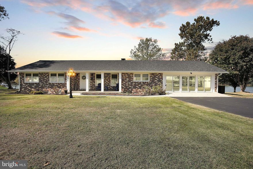 Stunning Waterfront Rambler! Move-In Ready! Experience the charm of coastal living in this beautifully renovated all-brick rambler perfectly situated on 1.19 acres with 262 feet of waterfront! From sunrise to sunset, enjoy 360-degree panoramic water views in a peaceful, private setting surrounded by mature trees and wildlife.  Step inside to discover 3 spacious bedrooms, updated 2.5 bathrooms, and a bright, open layout designed for comfort and entertaining. The living and family rooms share a dual-sided brick hearth fireplace with gas logs, offering the perfect place to gather and unwind. A 20’ x 20’ bonus room adds even more flexibility—ideal for a game room, home office, or media lounge.  The updated kitchen shines with brand-new quartz countertops, solid wood cabinetry, and stainless steel appliances—a true cook’s delight. Throughout the home, you’ll find new luxury vinyl plank flooring, plush carpet, and stylish wood-look laminate that complement the timeless brick exterior. 
Step outside to your large composite deck overlooking the water—a perfect spot for outdoor dining or morning coffee. The private pier comes equipped with power and water, a 12,500 lb boat lift, and a 1,000 lb Jet Ski lift. There’s even a boat ramp for easy launching into the deep, protected waters of the creek. The shoreline is secured with a bulkhead and rock revetment, and the new architectural roof ensures peace of mind for years to come. Additional highlights include:Two outbuildings with power, both featuring new roofs—perfect for workshops, hobbies, or storage. Spacious laundry room with tub. LED lighting throughout
Solid wood interior doors and 2x6 attic framing with full plywood decking. No HOA! Freedom to live your way without restrictions. Watch bald eagles, ospreys, mallards, and blue herons right from your backyard—nature lovers will feel at home here. The large paved driveway provides ample parking for guests, vehicles, and boats. Whether you’re seeking a full-time waterfront retreat or a peaceful weekend getaway, this property offers the perfect combination of quality, comfort, and tranquility. Don’t miss this rare opportunity to own your slice of waterfront paradise!