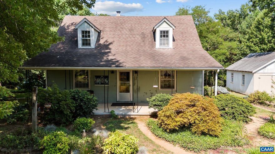 Charming and well-built Cape Cod set on 2.94 private acres, featuring beautiful oak hardwood and knotty pine floors throughout. This inviting home offers 3 bedrooms, 1.5 bathrooms, and a dedicated office, along with a welcoming covered front porch and a cozy enclosed back porch?perfect for enjoying the peaceful surroundings.  The full basement includes a wood stove flue and offers excellent potential for future expansion or additional living space. Outside, you?ll find a detached two-car garage with electricity on a concrete slab, plus a versatile shed/meat smokehouse.  The expansive, level yard is thoughtfully landscaped with a variety of trees and plantings that provide year-round color and interest. Ideally located just 2 miles from historic Scottsville, with easy access to the James River, local brewery, rafting, hiking trails, performing arts, shops, and dining.  A rare opportunity to enjoy privacy, character, and endless potential in a picturesque setting.,Wood Cabinets