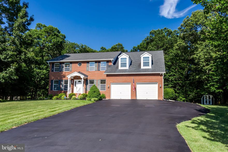 BIG BOLD BEAUTY is sitting at the head of this quiet cul-de-sac and is move-in ready. Majestically situated on a beautiful and private lot, this home has a lot to offer both indoors and out! Meticulously landscaped yard is a pleasure to drive up to and the Brick front with dormers offers true Colonial detailing. You will love all of the storage (cabinets included) in the oversized 2-car garage. The foyer has hardwoods, crown molding and chair rails and the whole house offers spacious rooms throughout! There is a formal living room and dining room, both with crown molding and chair railing and there are French doors between the dining room and kitchen. The huge fully equipped and updated kitchen features beautiful (and plenty of) cabinetry, 2 pantries, a built-in desk, granite countertops, stainless steel appliances and peninsula countertop and a built-in wine rack. It is a great lay-out for entertaining guests. There are French doors leading to the patio and screened gazebo in the back yard, as well as the kitchen is right off of the sunken family room. The two-story family room features gleaming hardwood floors and a dramatic floor to ceiling masonry fireplace. There are lots of windows for natural lighting. The office/5th bedroom has double door entry right off of the family room. The basement has a finished recreation room and there is loads of storage space, as well. There is easy access to the utilities in the basement. This home offers efficient dual zones Heat Pumps for cooling and heat along with a natural gas backup system. There is a large laundry room on the main level with a laundry sink, big closet and there is a convenient door to the outside. The front load washer and dryer convey with the property. On the upper level you will find the master suite plus 3 other generously sized bedrooms and a hall bathroom. The Master bedroom has a separate sitting area, and a spectacular humongous divided walk-in closet   it even has its own floored attic area   great for luggage storage or hiding gifts, etc.  The ensuite master bath features a jetted spa tub, separate shower, 2 separate vanities, ceramic flooring and tub surround and linen closet. Enjoy entertaining guests with plenty of parking in the oversized driveway and you will love the beautifully landscaped yard with Maintenance free Screened Gazebo with ceiling fan and electricity.  There is also a shed in the back yard. Come take a look. This home is currently in the North Point HS district and is conveniently located for easy commutes to Washington DC, Northern VA, the National Harbor ad Joint Base Andrews.