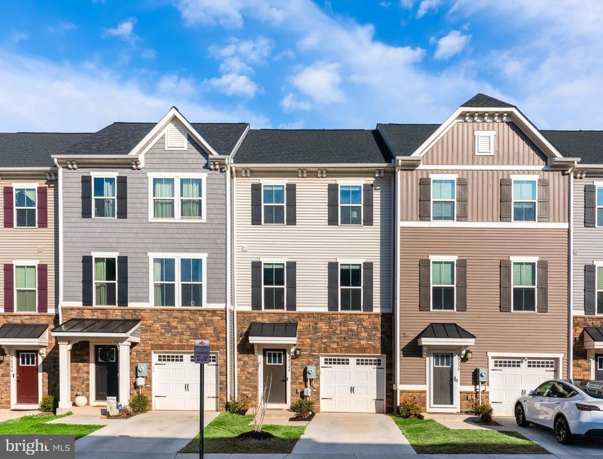 *OPEN HOUSE SATURDAY, 3/14 & SUNDAY, 3/15, 1:00-3:00PM* Perched atop a gentle hill in the sought-after Loudoun Overlook community within Cascade, this stunning 2022 Ryan Homes townhome offers modern design, expansive living space, and sweeping northwest views across Loudoun County with distant glimpses of the Blue Ridge Mountains.

Spanning approximately 2,340 square feet across four beautifully finished levels, the home features four bedrooms, three full bathrooms, two half bathrooms, and a one-car attached garage.

The main living level showcases an open, light-filled layout with luxury vinyl plank flooring throughout. At the heart of the home is the stylish chef’s kitchen, complete with quartz countertops, stainless steel appliances, a generous pantry, and an oversized island with seating and a built-in filtered water dispenser. The adjacent dining area opens directly to a composite and vinyl upper deck, creating the perfect setting for outdoor dining and entertaining. A spacious living room and powder room complete the level.

The entry level welcomes you with a dramatic family room featuring soaring ceilings, offering a flexible space for relaxing or gathering. This level also includes a powder room, garage access, and doors that lead to the lower deck and fully fenced grassy yard, which opens directly to the community’s basketball court, pickleball court, and tot lot.

Upstairs, the primary suite serves as a serene retreat with a large walk-in closet and a beautifully appointed en-suite bath featuring double vanities and a spacious walk-in shower. Two additional bedrooms, a full hall bath, and a conveniently located laundry room complete this level.

The top floor offers incredible flexibility, with a spacious bonus room ideal as a fourth bedroom, home office, or additional family room, complete with its own full bathroom and access to the private rooftop terrace, the perfect place to unwind while taking in sunset skies and sweeping views.

Residents of Loudoun Overlook enjoy fantastic community amenities including an outdoor pool, basketball court, pickleball courts, and playgrounds, while the home’s location places you directly across from Claude Moore Park, Recreation, and Community Center. Shopping, dining, and everyday conveniences are all just minutes away. Nearby schools include Sterling Elementary, Sterling Middle, and Park View High School, all within close proximity.

Combining modern finishes, flexible living spaces, scenic views, and an unbeatable location, this exceptional home offers the best of contemporary Loudoun County living.