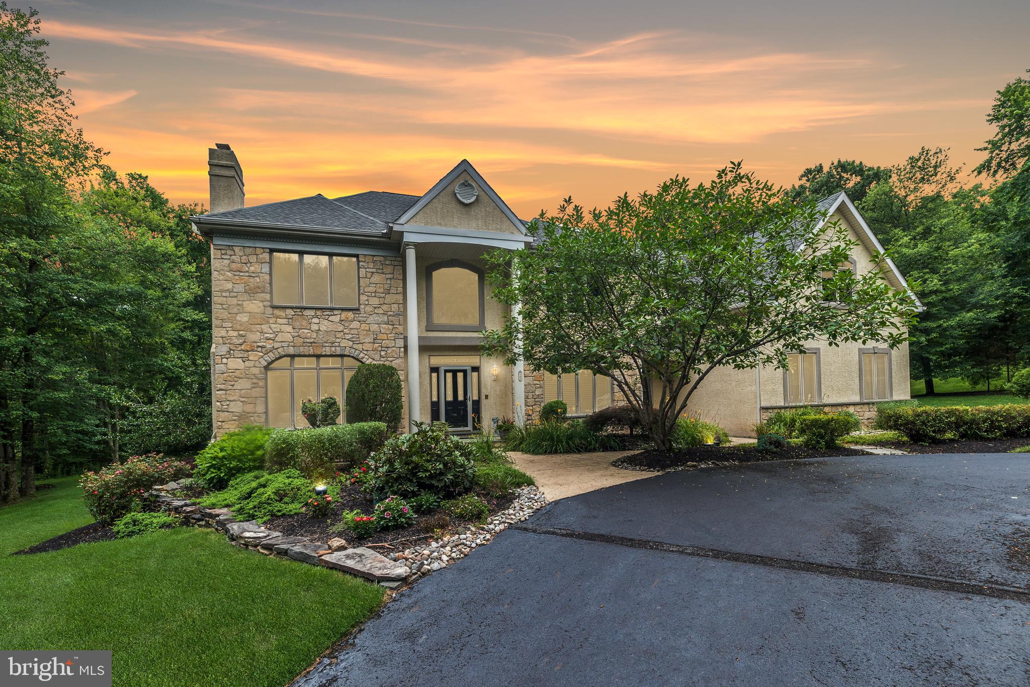 Luxury and serenity await on this rare offering in the heart of Solebury Township. Nestled on over 3 private, manicured acres at the end of a prestigious cul-de-sac just minutes from Peddler’s Village, this custom-built 6,000+ sq ft County Cork estate embodies elegance, comfort, and thoughtful design.
A sweeping circular drive sets the tone, leading to a stately two-story Foyer with gleaming hardwood floors. French doors open to a private Study—ideal for working from home—while the formal Living Room, anchored by a marble gas fireplace, exudes warmth and sophistication. Entertain with ease in the expansive Dining Room, with serene wooded views from every window.
The heart of the home is the exceptional Gourmet Kitchen—complete with two large islands, dual pantries, double ovens, Bosch dishwasher, 42" cabinetry, vaulted ceilings, and a breakfast area with panoramic views of the resort-style backyard and pool. The adjoining two-story Family Room features a dramatic floor-to-ceiling stone gas fireplace and a wall of windows that frame the peaceful rear landscape.
Feel like you're on vacation every day with the saltwater pool featuring a large waterfall and spa, surrounded by lush landscaping that enhances the secluded, private setting. Imagine dining poolside or hosting unforgettable summer gatherings in this serene oasis.
Upstairs, five spacious bedrooms include a luxurious primary suite with sitting area, three walk-in closets, and a spa-inspired bath. An en-suite bedroom and two others with a shared bath ensure space for everyone.
The daylight walk-out lower level is newly redesigned with impeccable finishes—ideal as a private guest or in-law suite. Enjoy a second full Kitchen with stainless steel appliances, Recreation Room, Media Room, full Bath for pool access, and abundant storage.
Additional features include: whole-house Generac generator, 2-zone HVAC (units 5 years young), AV water system, newer hot water heater, electronic security system, 8 zone Rain Bird irrigation, fenced rear yard with two gates, and a 4-car garage. Classic Keystone accents on the exterior pay homage to Pennsylvania architecture.
Located in the award-winning New Hope-Solebury School District, this extraordinary property is a truly one-of-a-kind offering—where luxury meets lifestyle.