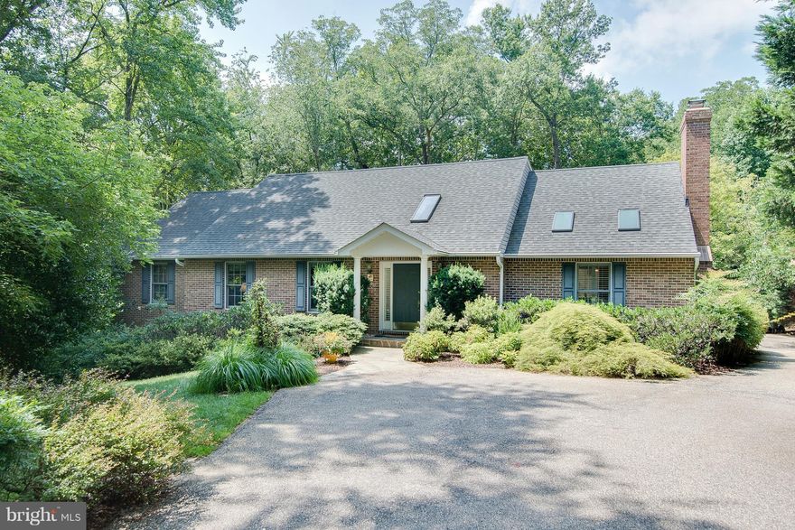 Cardinal's Rest -- custom brick-front cape cod in lovely 2-acre country setting.  Main-level master suite with 2 additional large BR plus BR/den and unfinished rooms and rough-in bath on upper level.  Gorgeous kitchen with adjoining family room, sun room opening to multi-level decks and stone patio overlooking landscaped gardens.  Huge unfinished bsmt walks out to back yard. Serene country living!