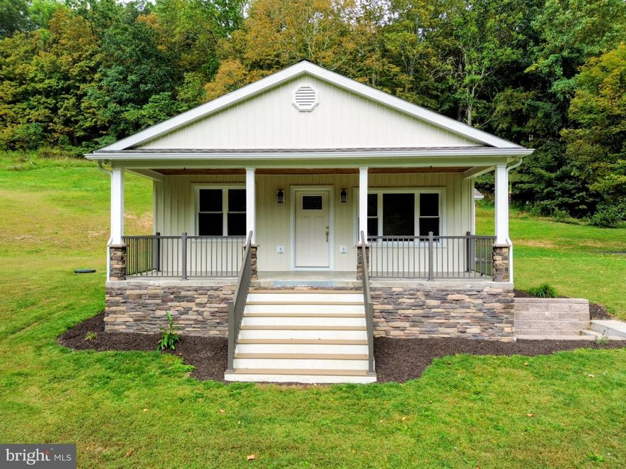 Nestled on a serene 3.05-acre lot, this charming cottage-style home offers a perfect blend of modern comfort and rustic tranquility. Built in 1949 and beautifully renovated in 2022, the property boasts an excellent condition with a partially finished basement, ideal for additional bedroom or storage. Step inside to discover an inviting open floor plan, featuring luxury vinyl plank flooring that flows seamlessly throughout. The gourmet kitchen is a chef's delight, equipped with upgraded countertops, a refrigerator, and a convenient pantry. Enjoy meals in the cozy dining area, or unwind in the living room by the electric fireplace, creating a warm ambiance for gatherings. The home includes two spacious bedrooms, each with closets, and three well-appointed bathrooms, including a luxurious walk-in shower. Recessed lighting enhances the inviting atmosphere, while energy-efficient windows ensure comfort year-round. Outside, the property is dream, complete with outbuildings for storage or equipment. The expansive grounds offer breathtaking mountain and wooded views, perfect for peaceful evenings or morning coffee on the porch. Located in a rural setting, this home provides a tranquil escape while still being accessible to nearby amenities. With ample parking and a layout designed for both relaxation and entertaining, this property is a true sanctuary waiting to welcome you home.