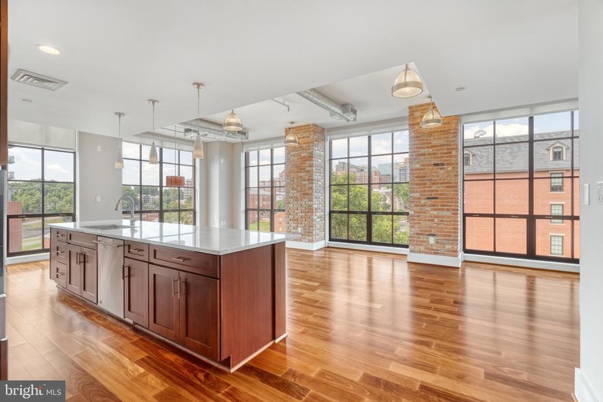 JUST REDUCED- RARE FIND!! Luxurious sun-drenched corner unit with walls of windows in the highly coveted Wooster Mercer Lofts that comes with two garage parking spots and a storage unit in building. New York-style loft with 10 ft ceilings, exposed brick, and high-end appliances, including Wolf stove and SubZero fridge. Granite kitchen,  gas fireplace, luxurious shower w/ dual shower heads, 2 custom-built walk-in closets, with additional built-in closets in bedroom. Dual vanities in both baths, pre-wired for surround sound. in addition to pool and fitness center. Steps to Ft Myer, and short ride to the Pentagon and Main State. 95% walkability score- Rosslyn & Court House Metros (0.5 mile), shops & restaurants are all nearby!