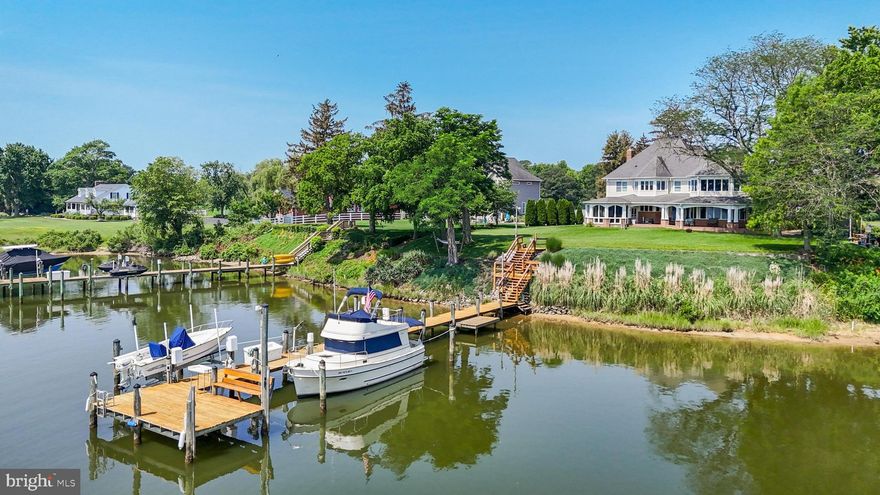 WATERFRONT! NO HOA! DEEP WATER! FLAT LOT! What more could you want? From the moment you arrive, the wide water views of Island Creek pull you in. The backyard is a true highlight, with a rock bulkhead lined with juniper plants, your own little beach at low tide, and a private pier equipped with electric, water, and two boat lifts. A space to clean your fish and catch all of the fresh crabs (see photos in listing). Do you have a camper or boat you want to store on your own property? With no HOA, and a designated spot on the side of the house - you can have that!! Thinking of taking up gardening? There is a set of self-watering raised garden beds on the other side of the house, ready for your summer vegetables. A stamped concrete patio (newly sealed) stretches the full length of the home, the screened-in porch makes it perfect for steaming and eating the crabs you just picked off your pier, and the 12x10 shed gives you extra storage for tools or water toys. Step inside through the oversized 30x22 garage and into a well-planned mudroom with a large closet that connects directly to the laundry room. The kitchen is a standout — water views from every angle, stainless steel appliances, Corian counters, a walk-in pantry, and a layout that opens into the great room. A stone-surround gas fireplace anchors the space, making it feel cozy without sacrificing the view. Upstairs, you’ll find four spacious bedrooms, all with oversized closets. The primary suite is thoughtfully designed with electric blackout blinds, three large closets, and a spa-like en-suite with double sinks, a soaking tub, and more views of the water. There’s also a second owner’s suite on this level, perfect for guests or multi-generational living. Two staircases make the layout feel open and accessible, and that is needed with over 4,600 square feet of finished space. The huge unfinished basement offers even more potential, this home is ready for whatever you need it to be — all in a peaceful setting, within a few minute boat ride to the Patuxent River, with no compromises on comfort or convenience.
