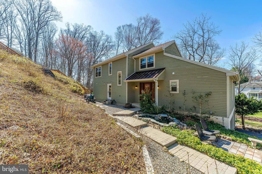 Welcome to 150 Poplar Road, a 4-bedroom, 3.5-bathroom contemporary home set on nearly an acre of private, wooded land in Newtown Square. Tucked away for maximum privacy, this property offers a peaceful setting complete with a scenic creek running alongside the home and a beautifully secluded in-ground heated pool, accessed by deck stairs, creating your own private outdoor retreat. As you arrive, you’re greeted by a welcoming foyer with tile floors. The living room features hardwood floors, a vaulted ceiling with skylights, a ceiling fan, and a wood-burning fireplace, filling the space with natural light and warmth. Just beyond is the dining room with hardwood floors, a chandelier, and sliding doors leading to the screened-in porch, the perfect place to unwind with a ceiling fan and overhead lighting for comfort throughout the seasons. The adjacent sunroom continues the bright, airy feel with hardwood floors, vaulted ceilings with skylights, and multiple windows overlooking the serene surroundings. The kitchen is well-appointed with tile floors, granite countertops, new stainless steel appliances, including a brand new top-of-the-line induction oven, a center island with pendant lighting, space for a breakfast table, and a convenient butler’s pantry. The main-level primary suite offers carpet flooring, a walk-in closet, and a private en-suite bathroom with heated tile floors, a walk-in shower, and a heated towel rack. A powder room completes the first floor. Upstairs, you’ll find a versatile home office with built-in cabinetry, along with three additional bedrooms, all with carpet flooring. Two of the bedrooms are connected by French doors, offering flexibility for shared living or additional workspace. A full hall bathroom with a tub/shower combo completes this level. The finished lower level expands your living space with a full bathroom featuring a jetted tub, a spacious rec room with a wood-burning fireplace, and a bonus room with sliding doors to the yard—ideal for a home gym, playroom, or guest space. This level also includes a laundry room, access to the garage, and additional storage. Outside, the property truly shines. The private wooded setting, creekside backdrop, and elevated heated in-ground pool create a unique outdoor experience that’s perfect for relaxing or entertaining. All of this is conveniently located just minutes from shopping, dining, and major routes, and within walking distance to the local library, township park, baseball fields, and Ellis Preserve. Don’t miss the opportunity to make this private retreat your next home.