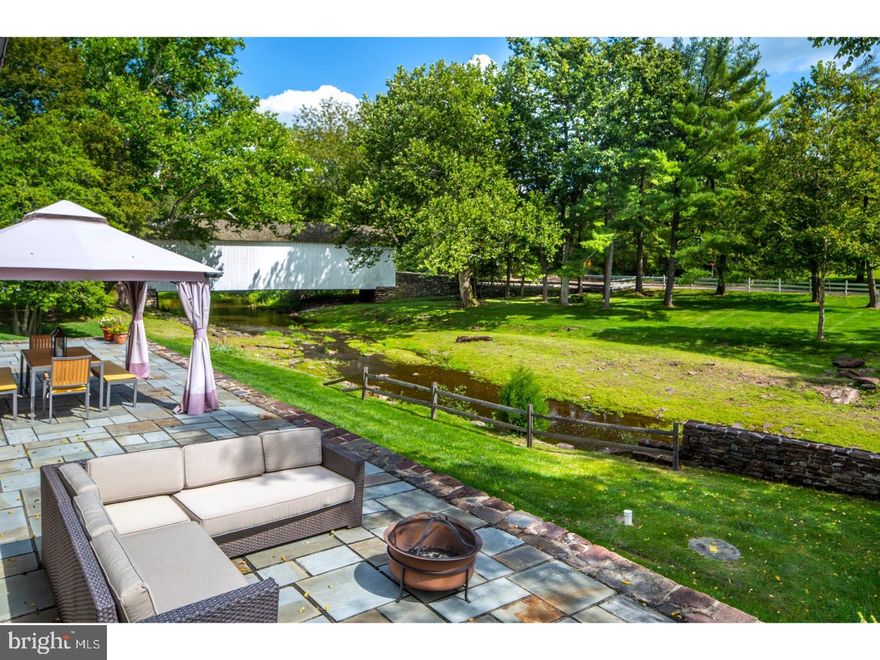 SALE PENDING Nearly eight idyllic acres envelop this late 1700's farmhouse, bank barn and cottage in scenic Bucks County. Stone walls and walkways, gardens to delight the senses, and a creek side view are found at Cabin Run, an extraordinary country estate with a magical setting. The original stone residence offers covered porches, random width wood floors, pie stairs and windows with deep sills. Walk-in stone fireplaces accent the living room and dining room. A recently remodeled kitchen impresses with granite and tile surfaces, upscale stainless appliances, and doors to the flagstone patio, a serene vantage point to experience the beauty of the majestic grounds. Meticulously restored, the stone and wood barn brings vast space for equipment and vehicles. A carriage house is a charming residence of its own, nicely equipped with an office, laundry room, bedroom and bath. A bountiful orchard, inground swimming pool, and abundance of mature trees and colorful plantings enhance this very special property.  Winding country roads with covered bridges lead to shopping and dining along the Delaware River and major thoroughfares are easily reachable for quick access to Philadelphia and New York City.