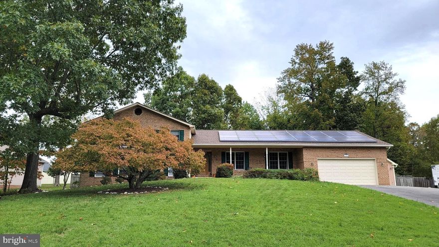 This Home Qualifies for 100% Financing. Beautiful 3/4 brick split-level home in Quailwood, lovingly maintained by the  owners. Situated on a quiet cul-de-sac lot nearly half an acre in size. Recent upgrades include a new dishwasher, new water heater, solar panels, and a roof that was replaced Dec 2022.  Upstairs, you'll find two spacious bedrooms and two bathrooms. The lower level boasts a large family room with a stone fireplace and access to the backyard, as well as an additional bedroom and full bathroom. There is also a sizable laundry area and an oversized two-car garage.  An additional 1 car Detached Garage allows for additional storage.